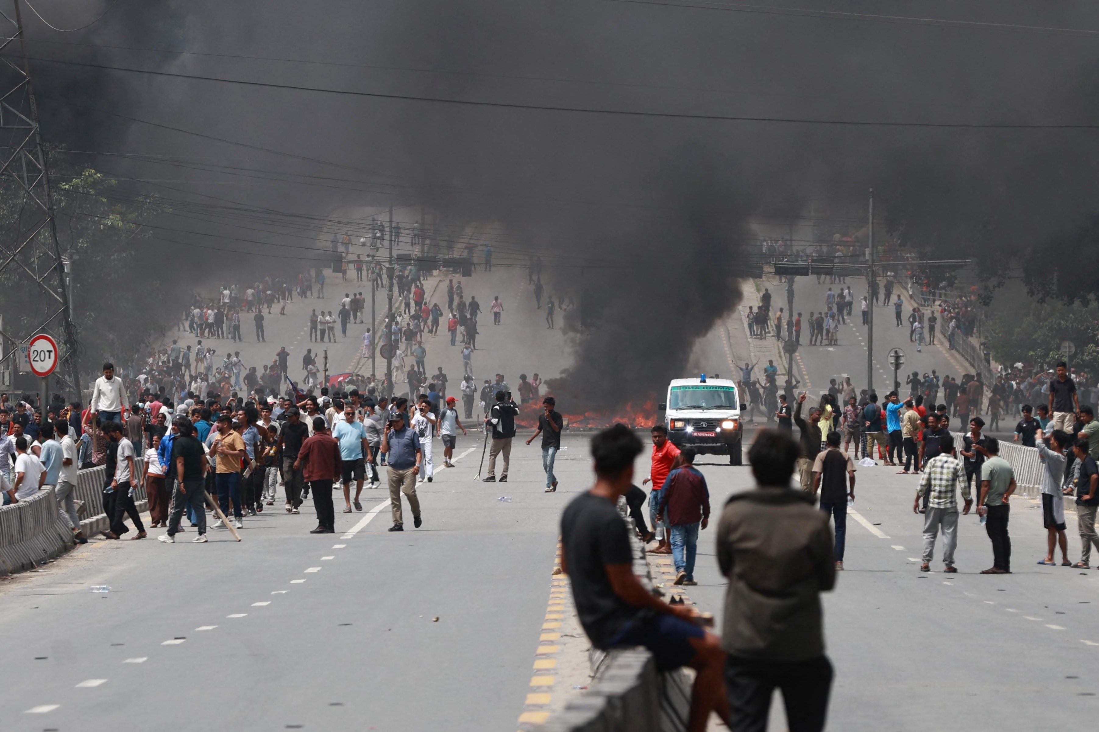 A fire burns as demonstrators gather on a road during a protest to condemn the police's deadly crackdown on demonstrators in Kathmandu on Tuesday 9 September