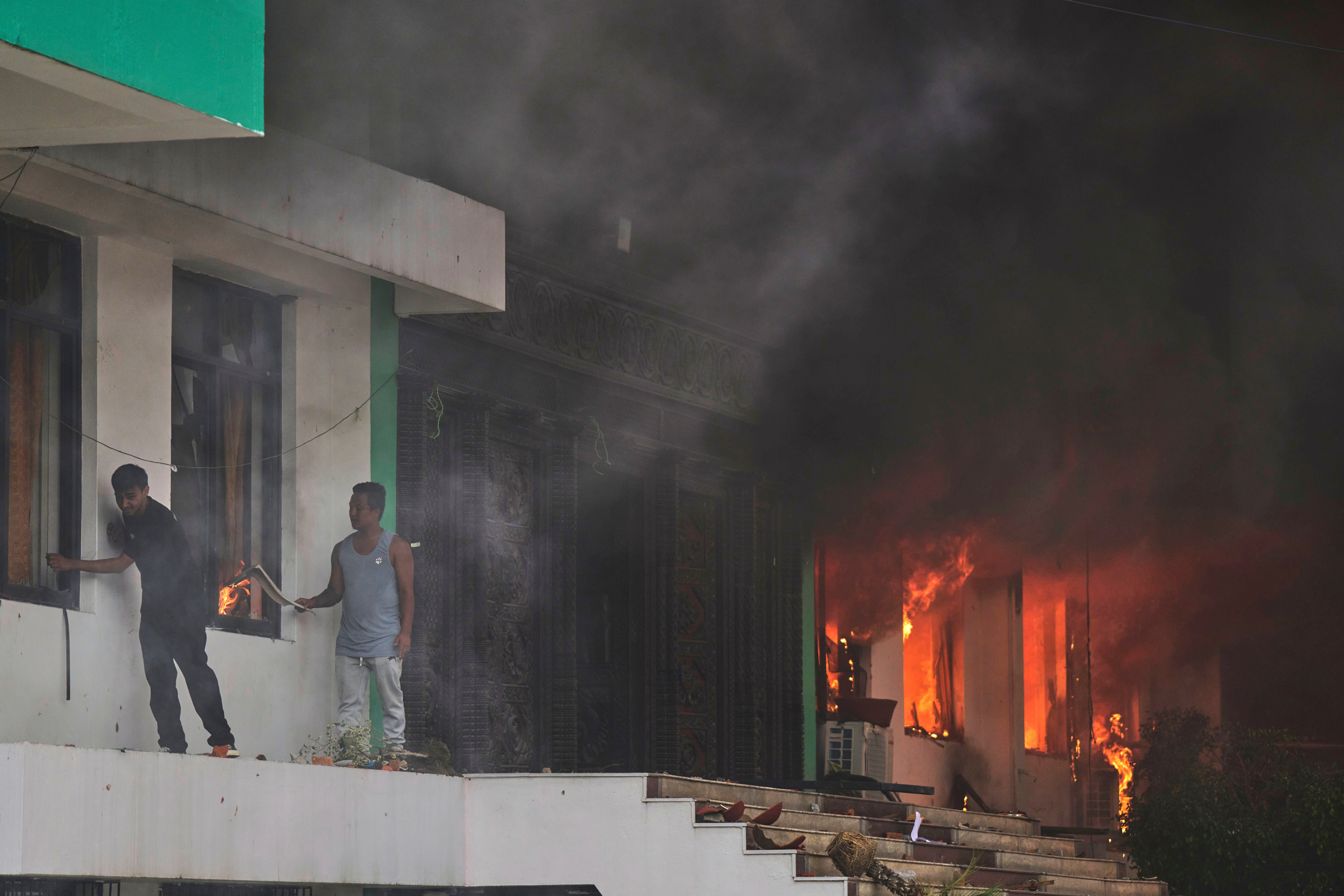 Protesters set fire to the Nepalese Congress Party central office in Kathmandu, Nepal, on Tuesday