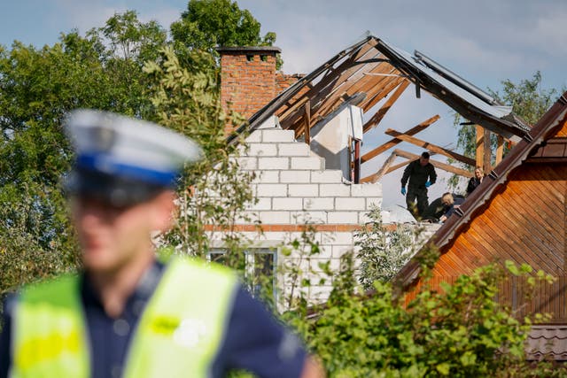 <p>Police and army inspect damage to a house destroyed by debris from a shot down Russian drone in the village of Wyryki-Wola, eastern Poland</p>