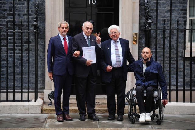 Campaigners Avi Shlaim (secnd right), Munib al-Masri (second left) and his grandson Munib Masri Junior (right) with the Britain owes Palestine 400-page legal petition outside number 10 Downing Street (James Manning/PA)