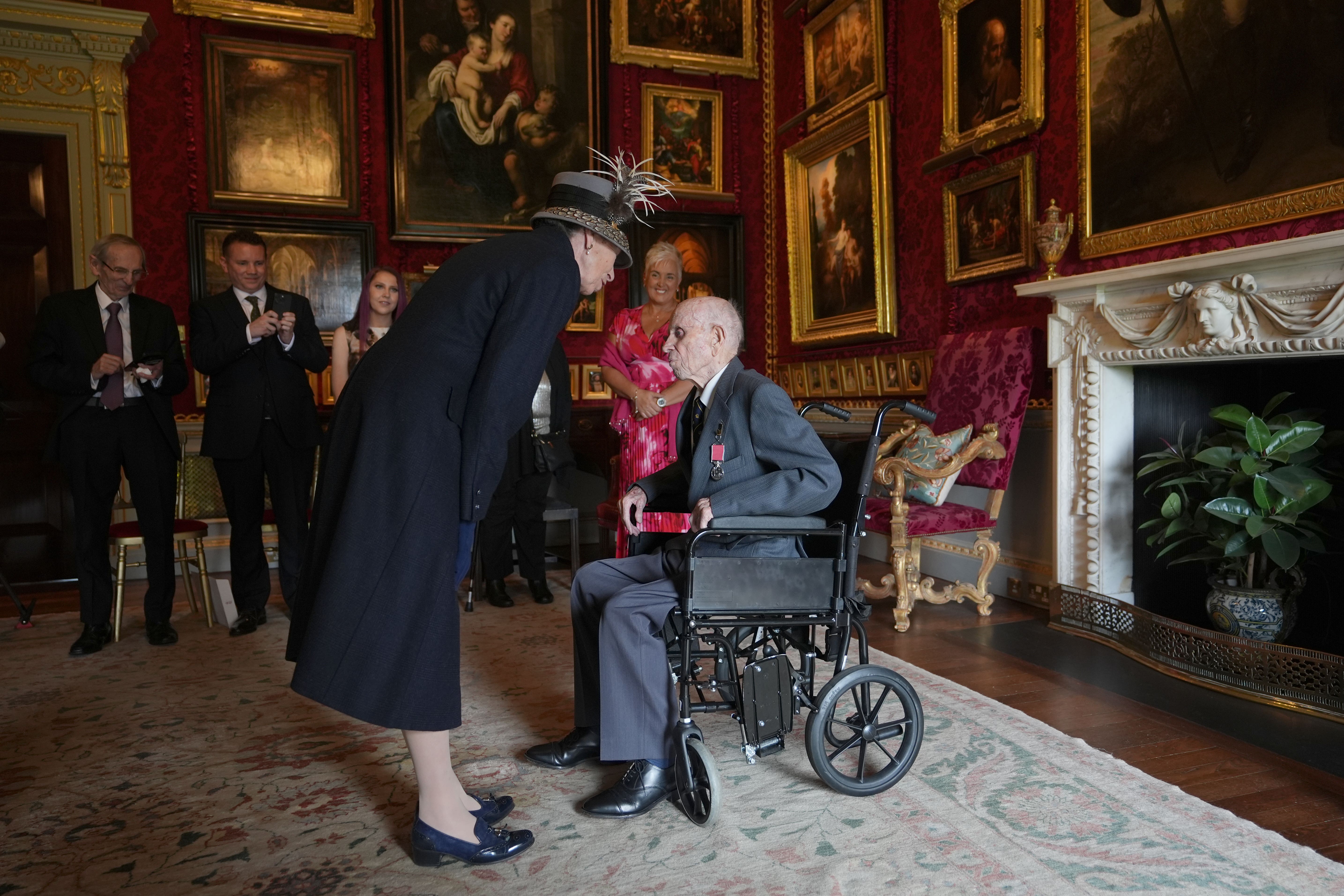 The Princess Royal presents Norman Irwin with the British Empire Medal (Niall Carson/PA)