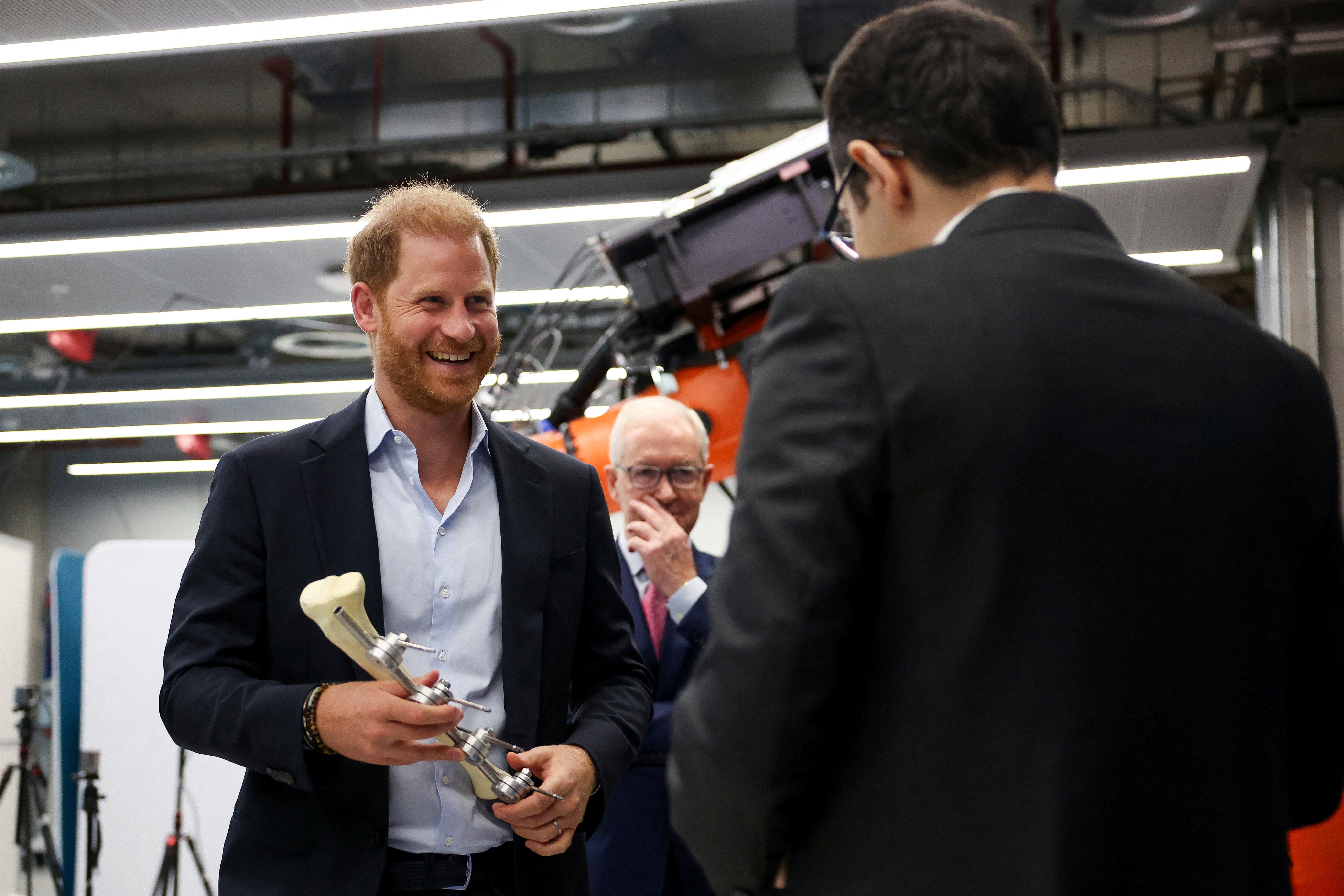 <p>Britain's Prince Harry holds an Imperial External Fixator during a visit to the Centre for Blast Injury Studies at Imperial College London</p>