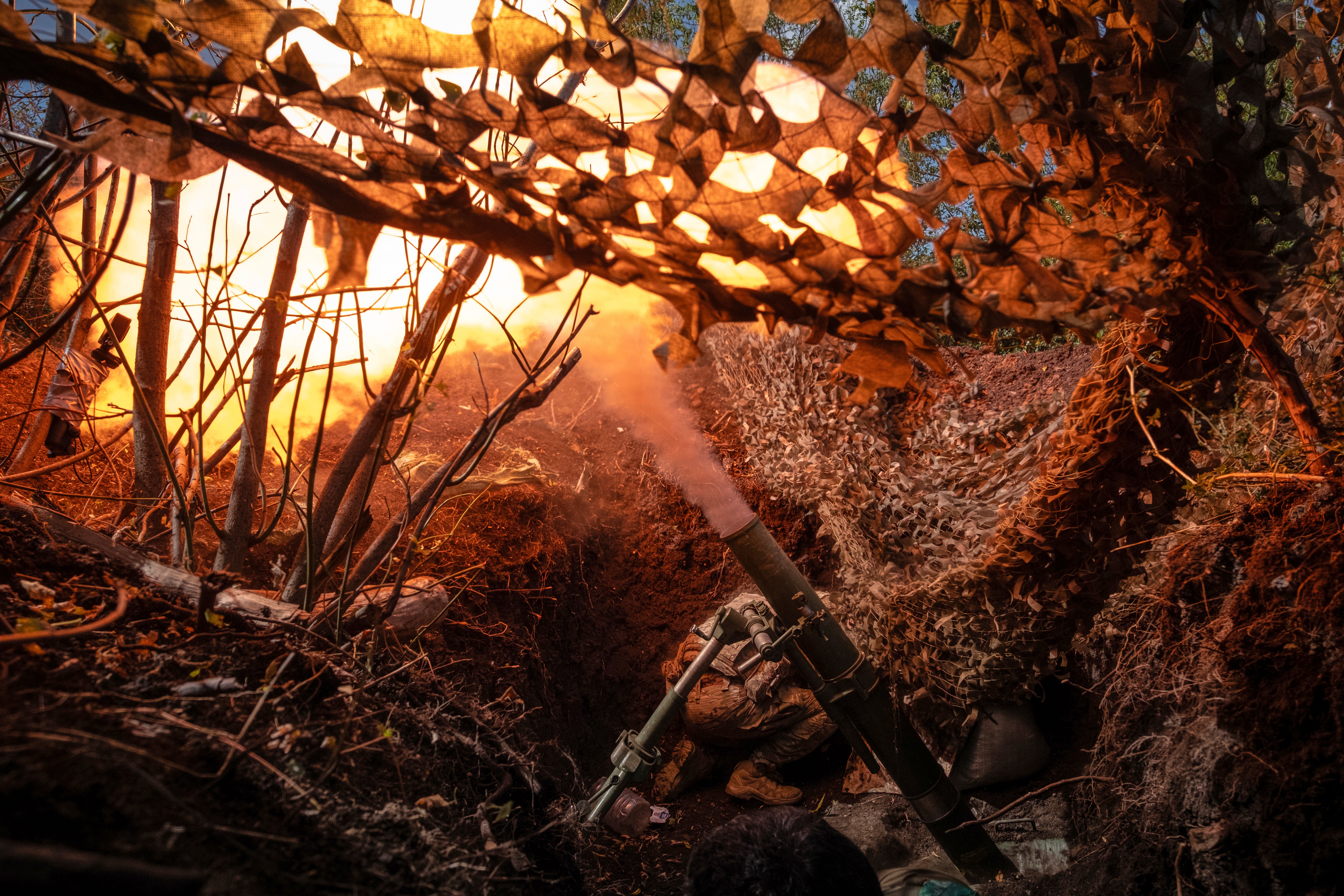 A Ukrainian soldier fires a mortar towards positions of Russian troops near Kostyantynivka in Donetsk region