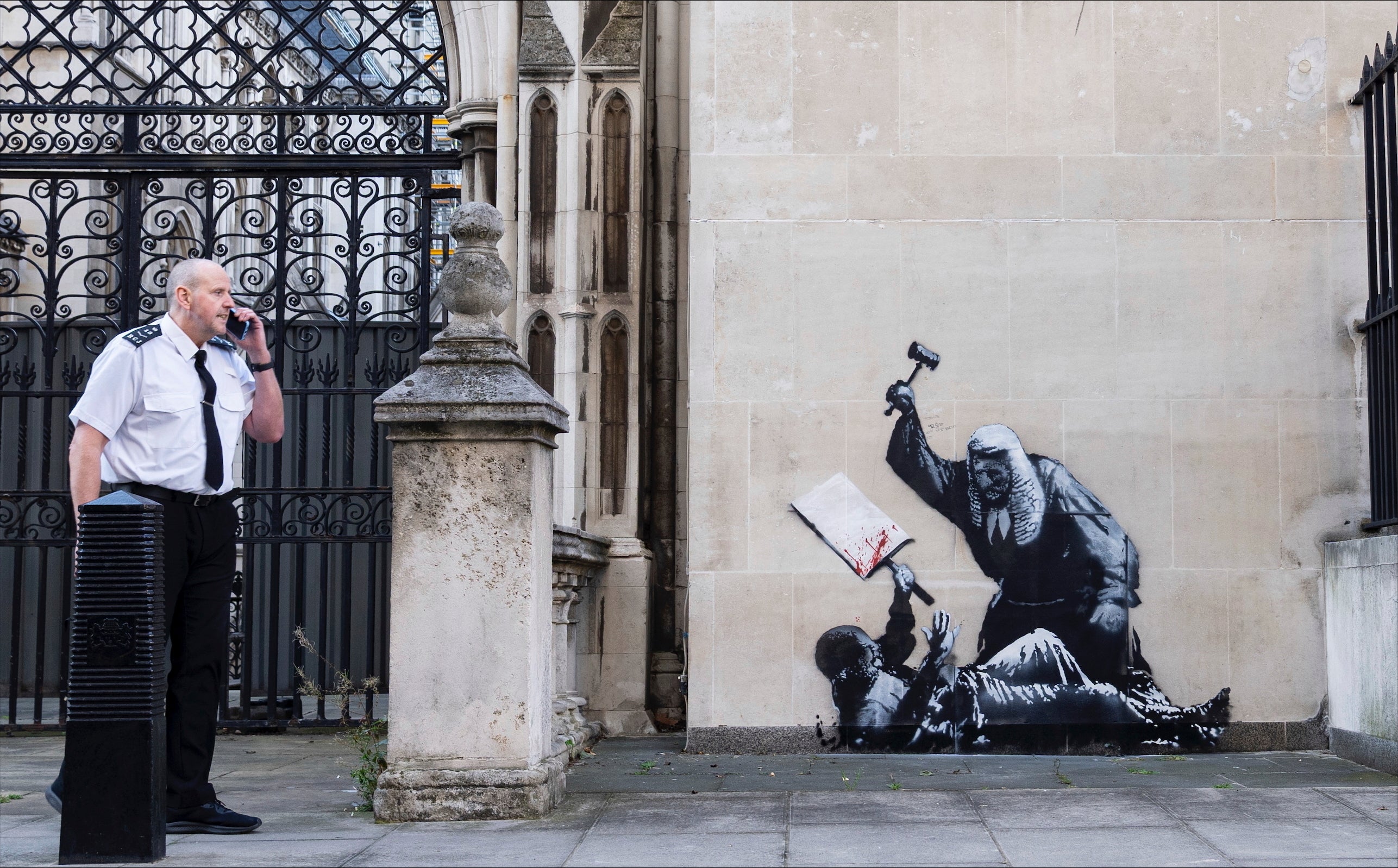 The new artwork by Banksy, which portrays a judge beating a protester with a gavel at the Royal Courts of Justice in London