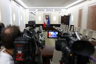 Members of the media wait at the Chancellery of the Prime Minister
