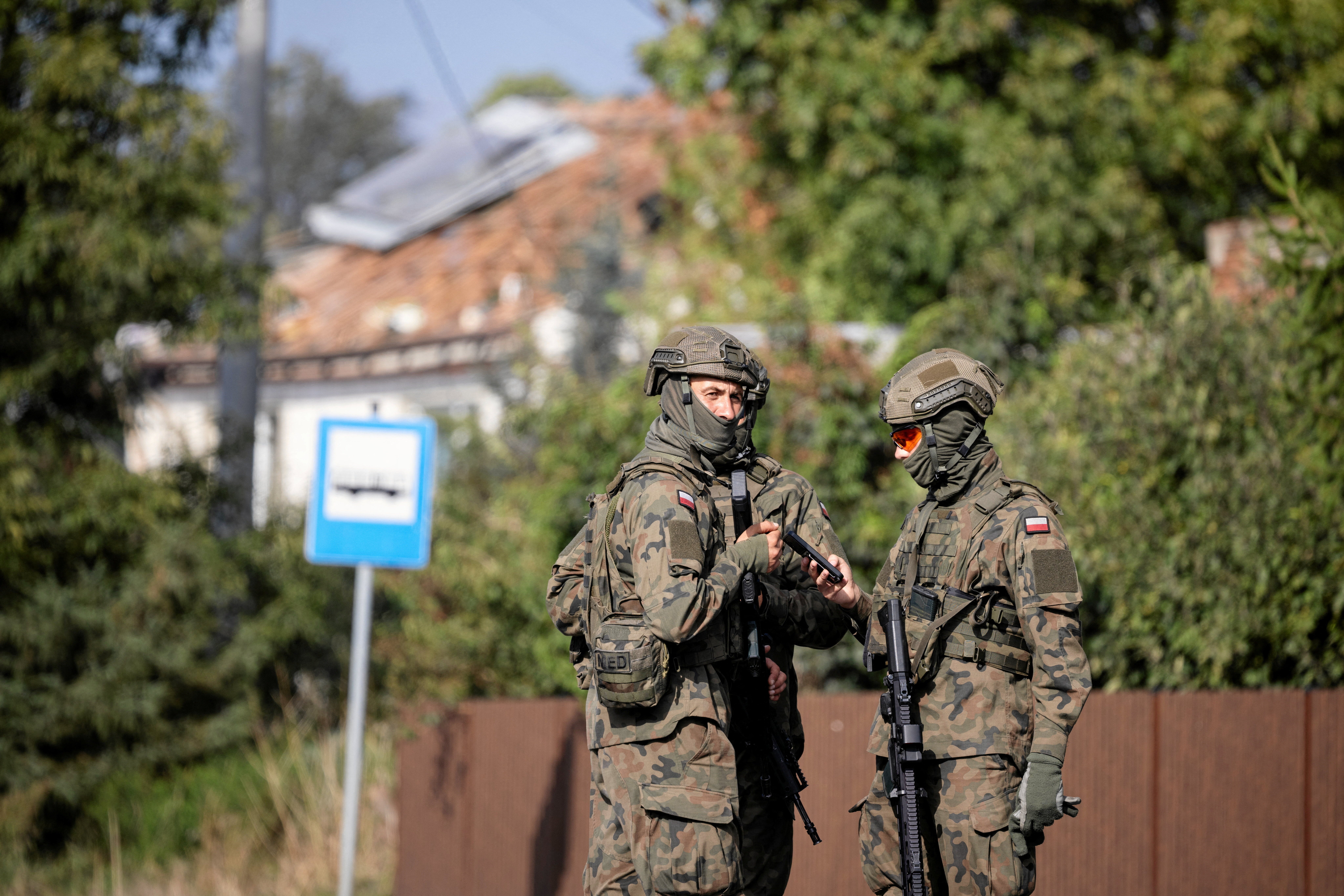 Soldiers patrol the street in Poland after a drone struck a residential building
