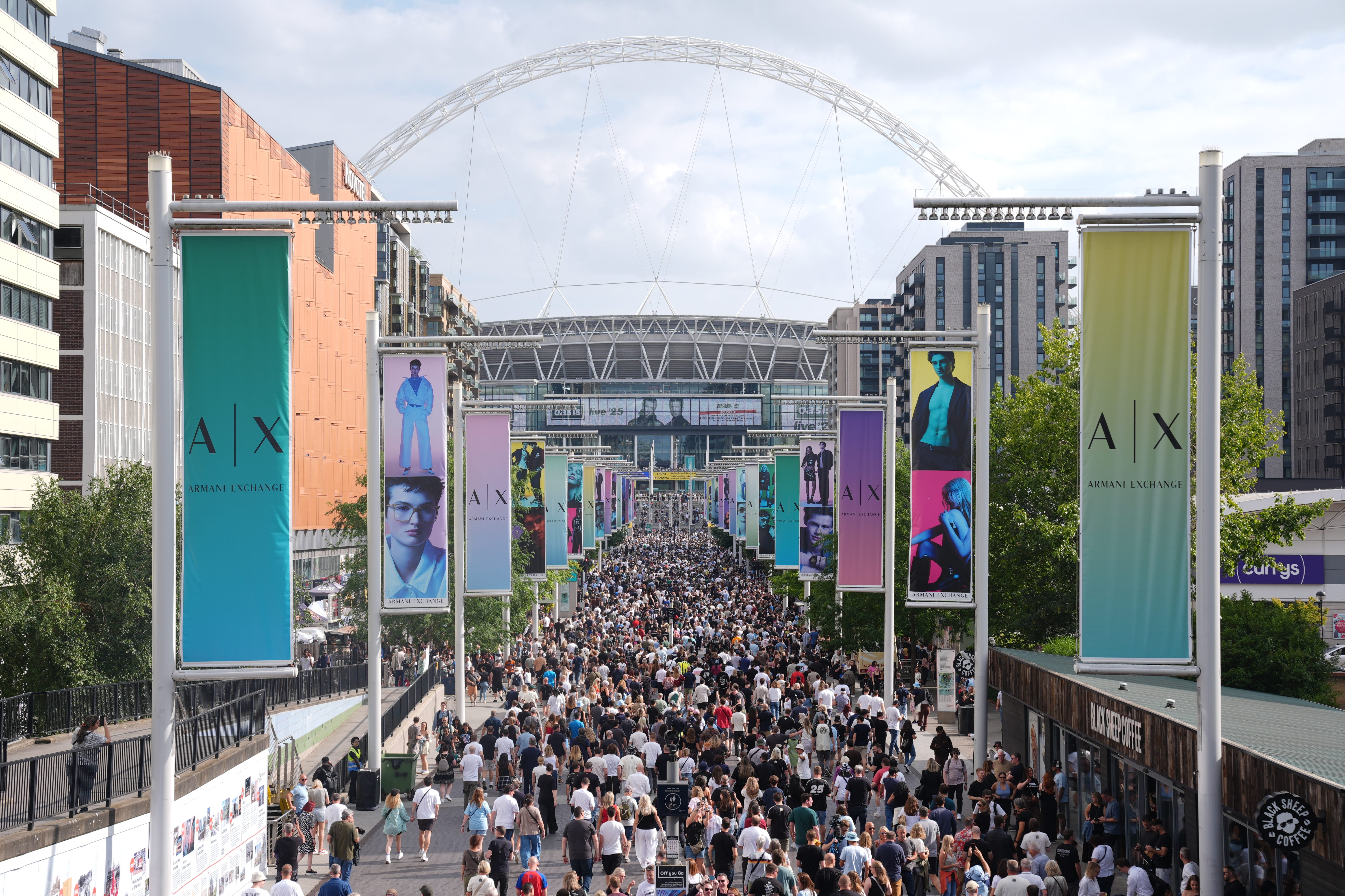 <p>Fans on Wembley Way ahead of an Oasis gig (Lucy North/PA)</p>