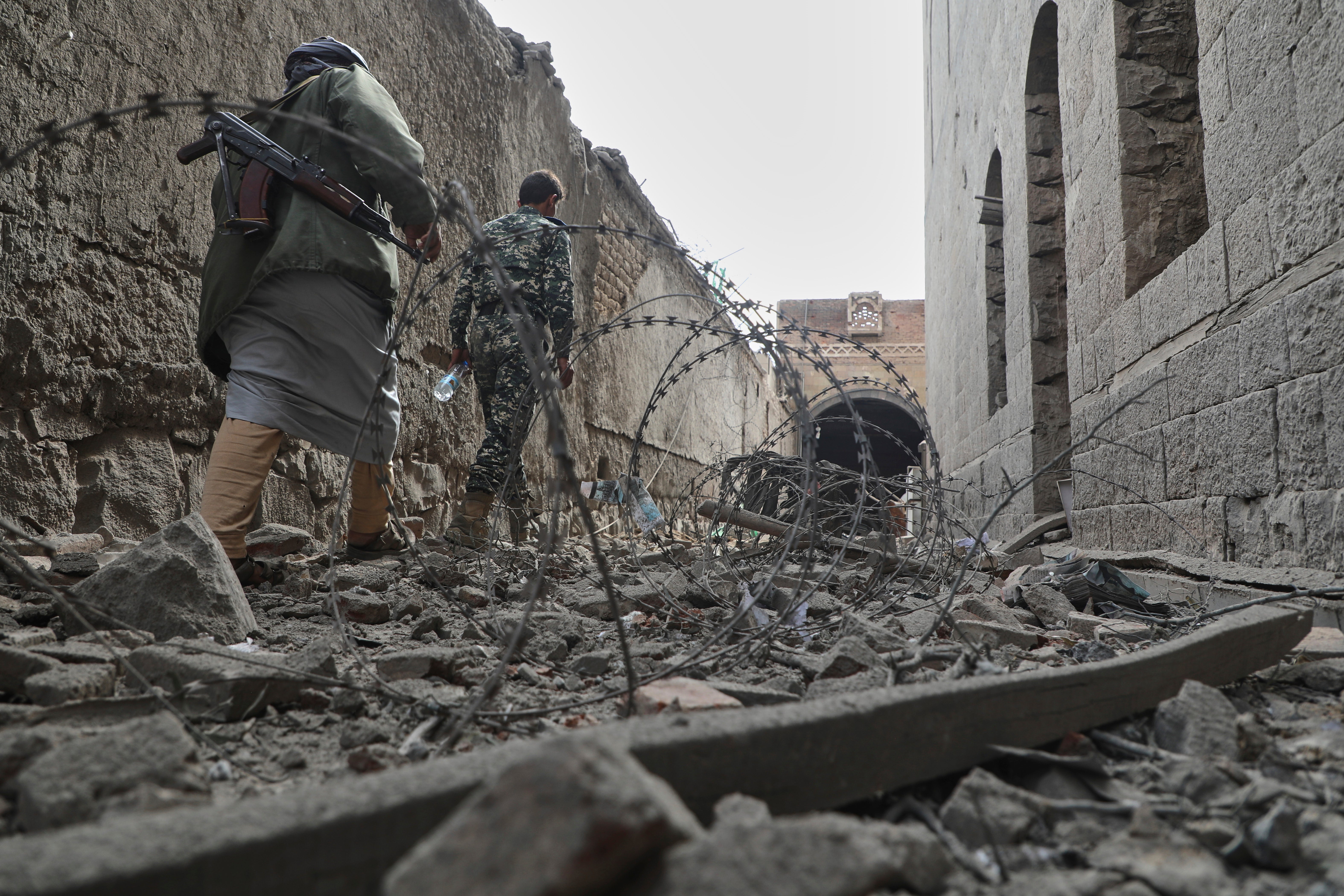 <p>People inspect the damage at the National Museum in Yemen after airstrikes earlier this year</p>