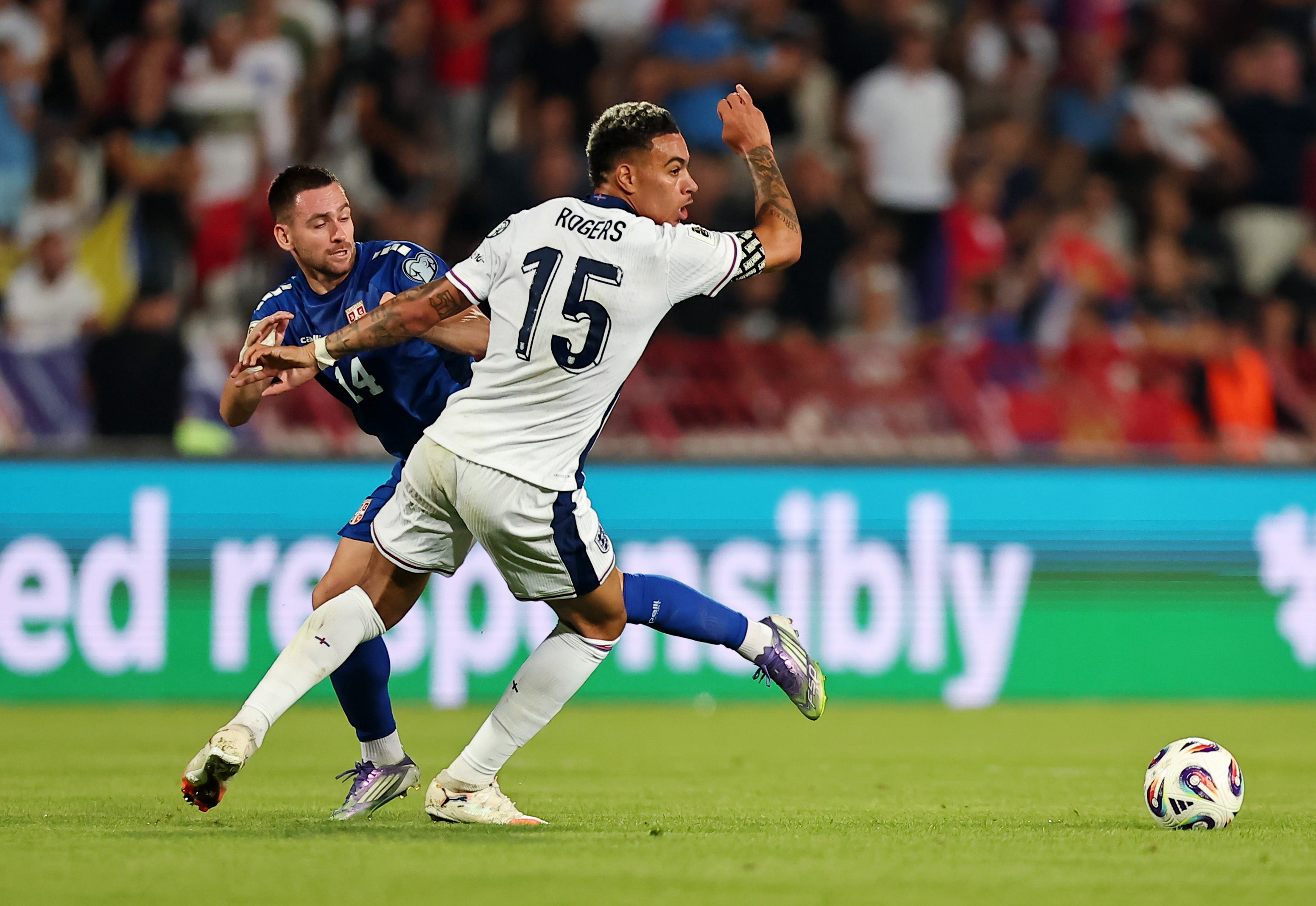 <p>Morgan Rogers of England and Andrija Zivkovic of Serbia battle for possession </p>