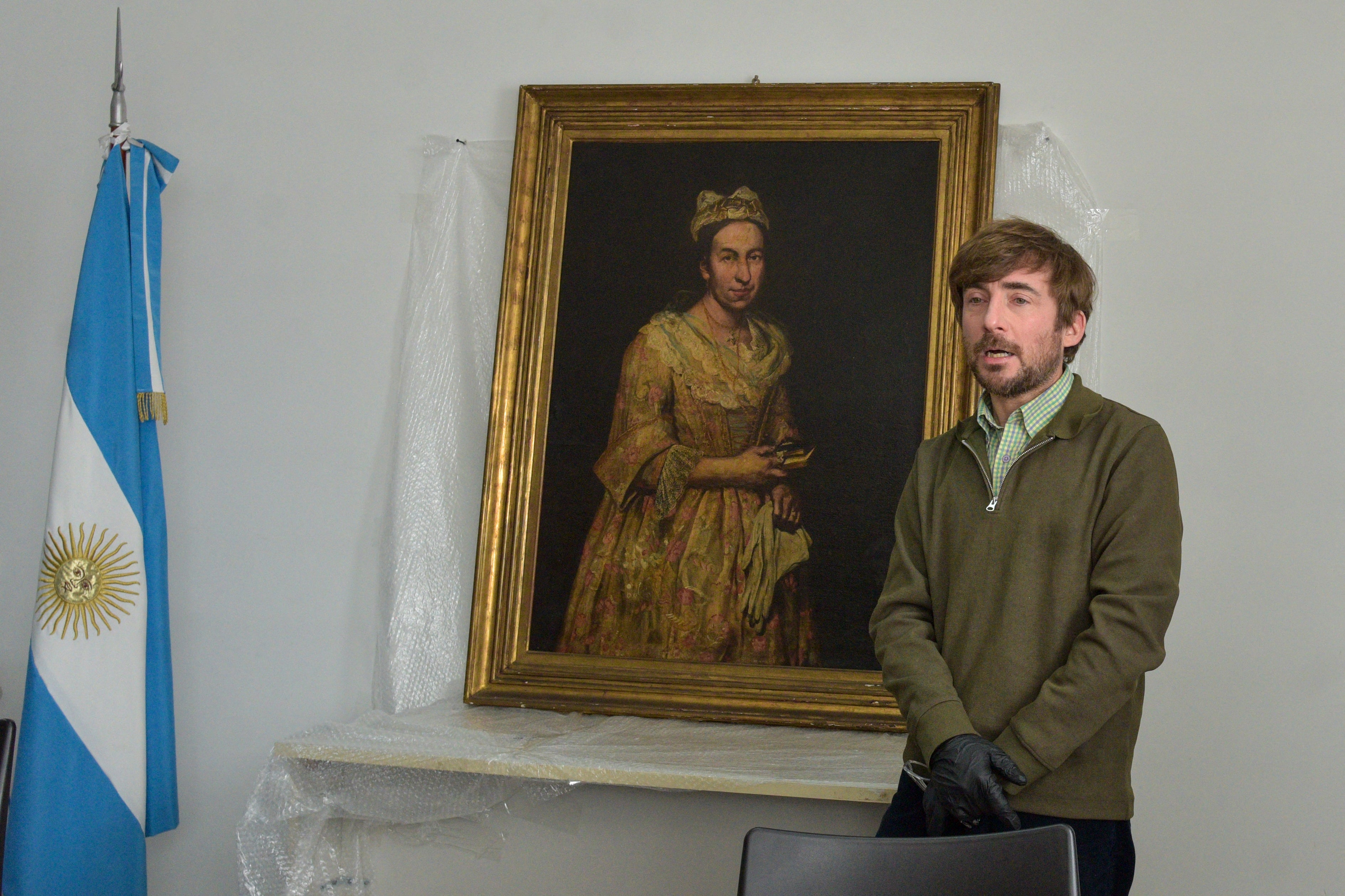 Visual arts teacher Ariel Bassano speaks in front of the recovered painting believed to be ‘Portrait of a Lady’ by Giuseppe Ghislandi, in Mar del Plata, Argentina, on 3 September