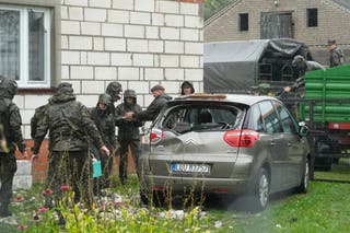 Territorial defence officers clean up debris from the destroyed roof of a house after Russian drones violated Polish airspace during an attack on Ukraine in Wyryki near Lublin in Poland
