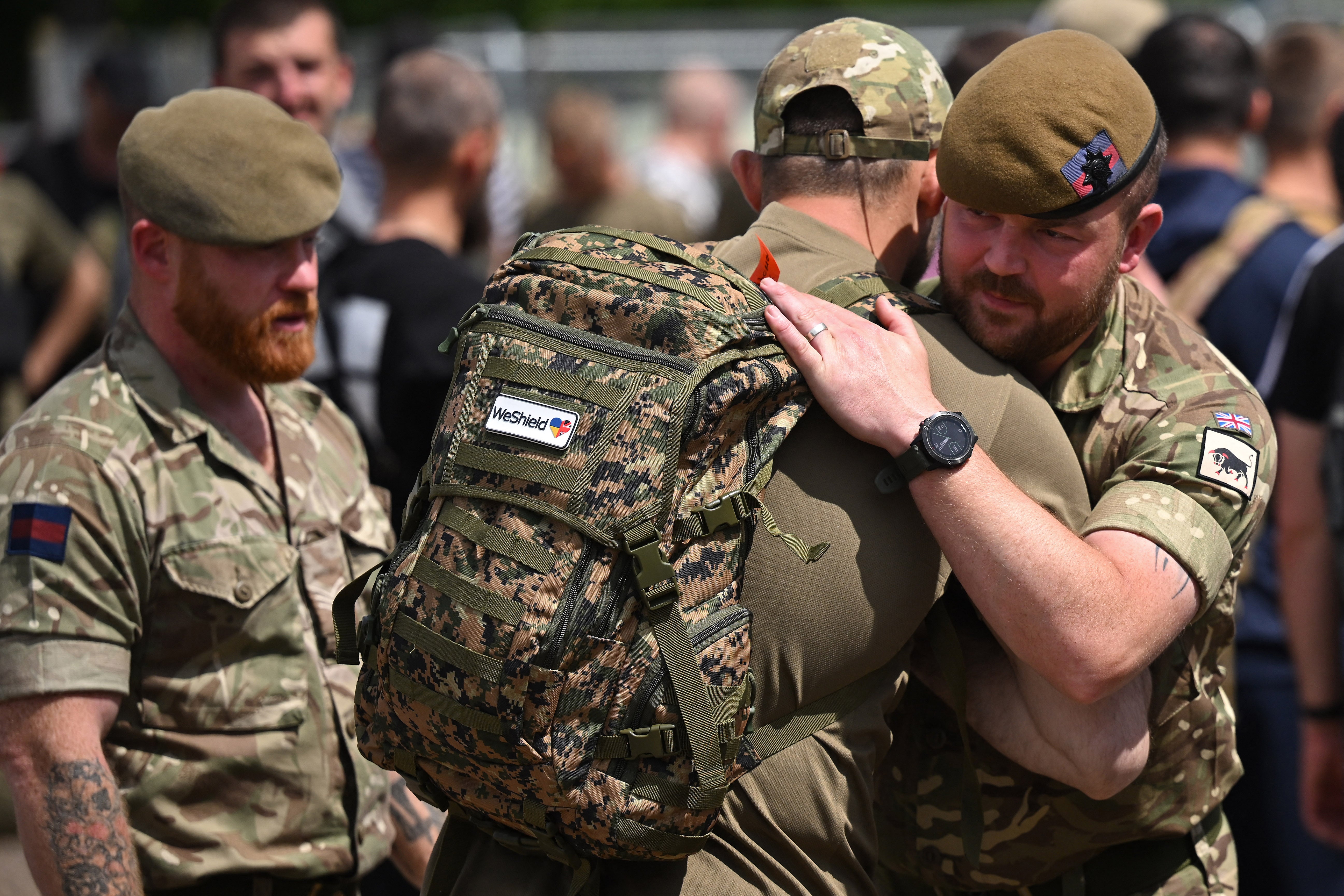 Ukrainian soldiers are embraced by British troops after taking part in a training exercise as part of the Interflex programme in June this year