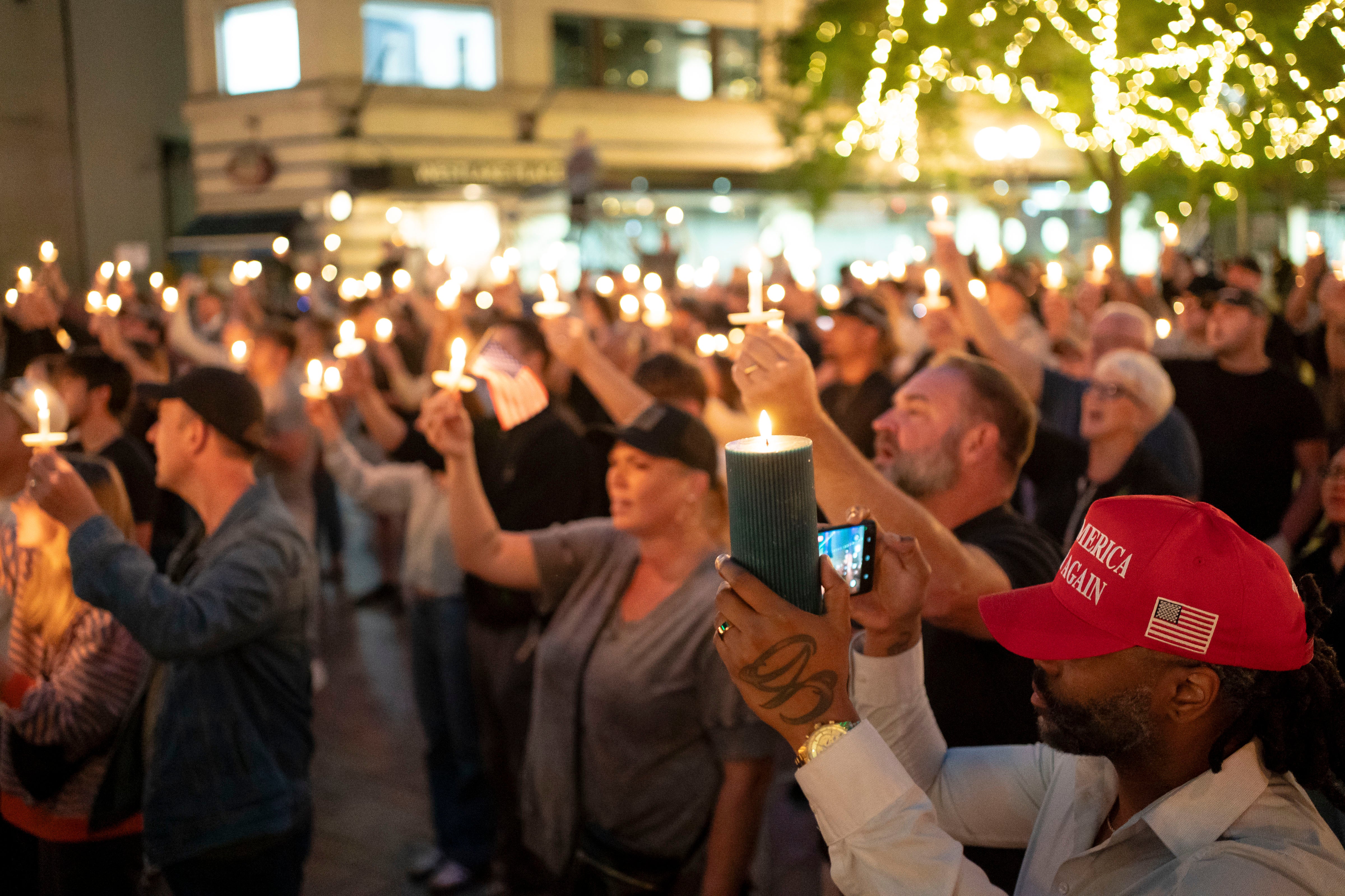 Attendees hold candles during a candlelight vigil and prayer event for Turning Point USA Founder Charlie Kirk in Seattle, Washington