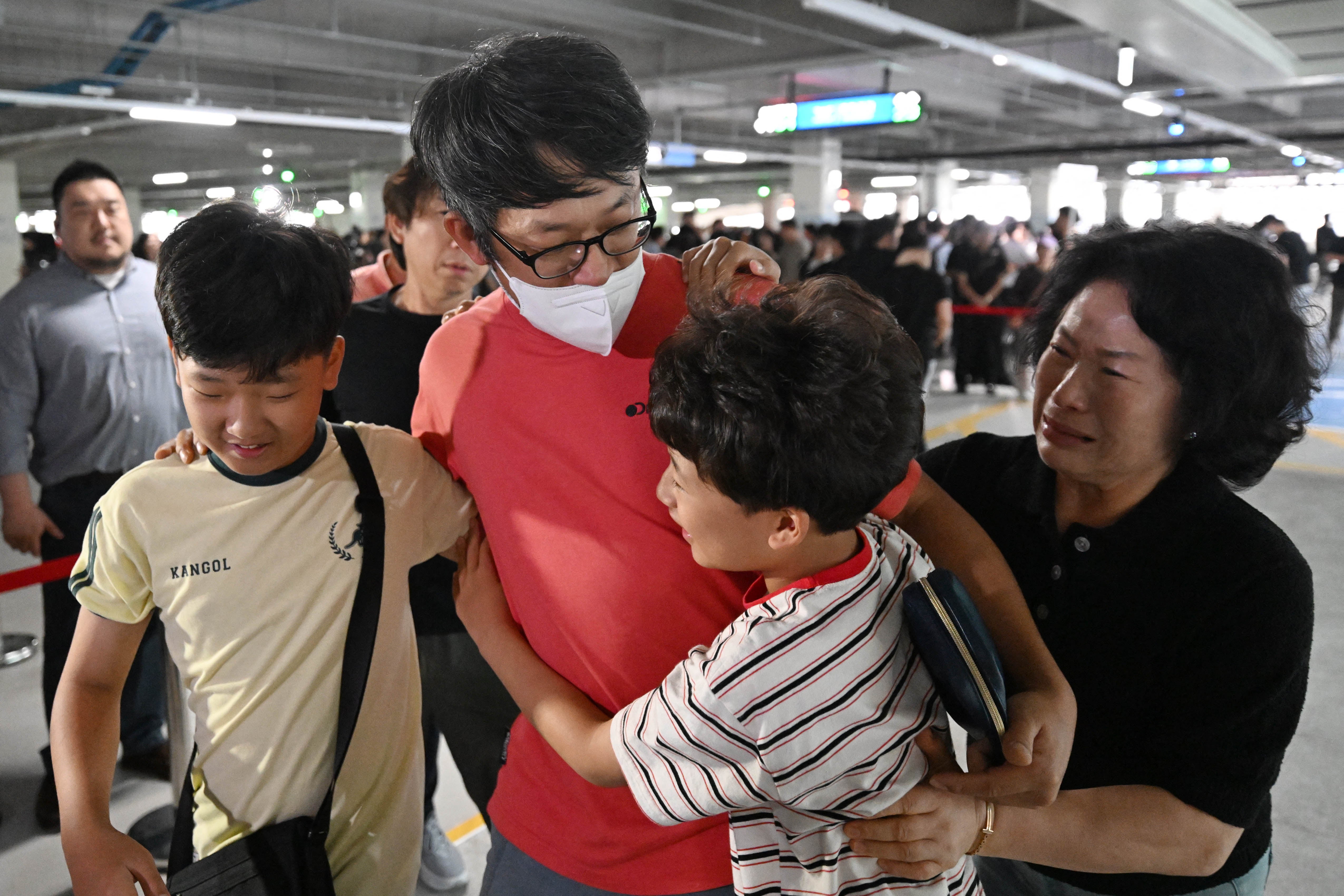 <p>A South Korean worker detained during an immigration raid at a Hyundai plant in Georgia, US, is welcomed by family members after arriving at the Incheon airport in Seoul</p>