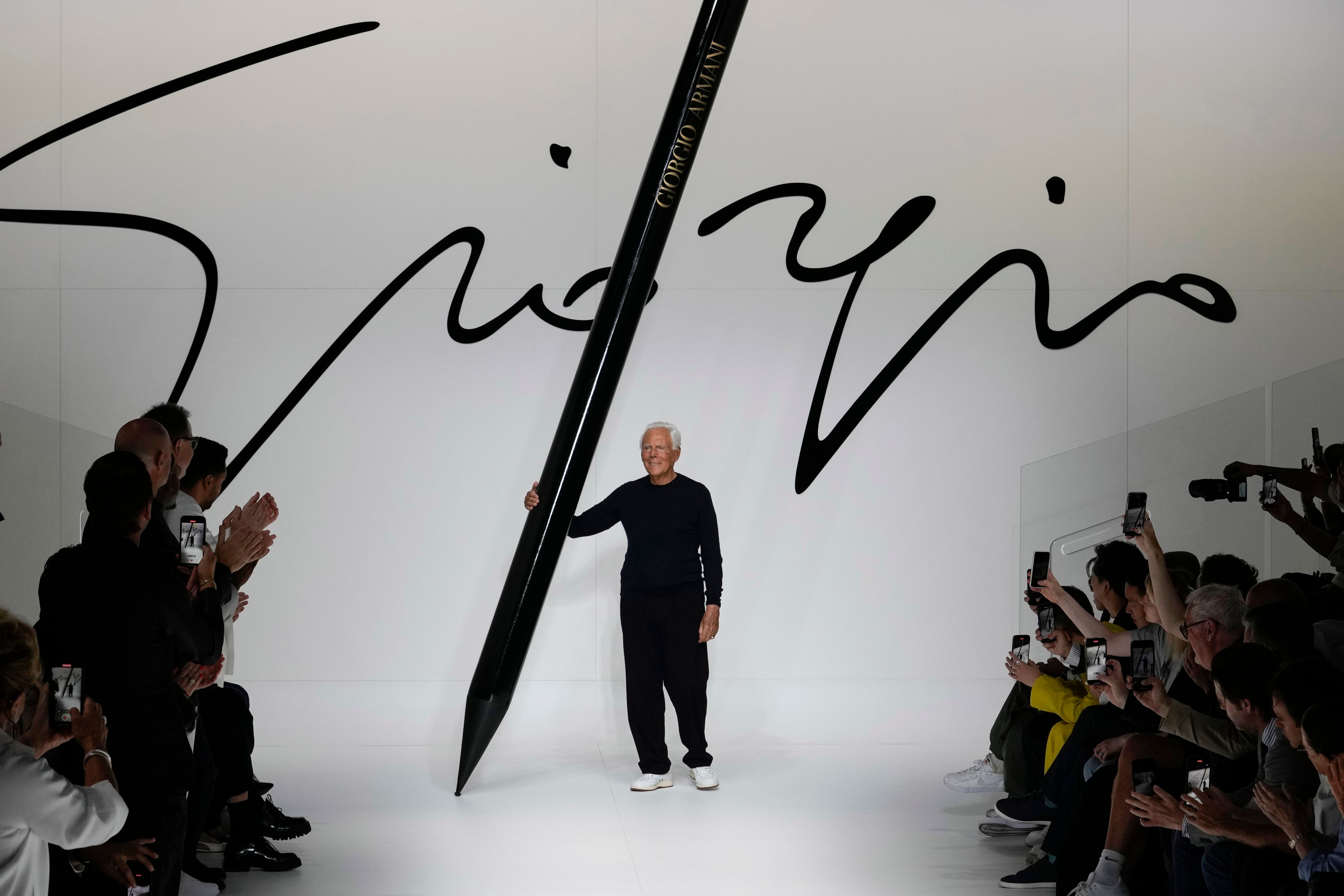 Designer Giorgio Armani receives applause at the end of the Giorgio Armani men's Spring Summer 2024 fashion show presented in Milan, Italy,, June 19, 2023. (AP Photo/Luca Bruno, File)
