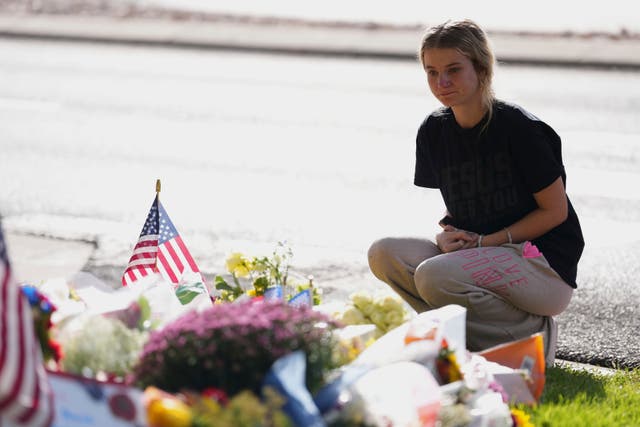 <p>Meagan Bradley kneels at a memorial set up for Charlie Kirk at Utah Valley University in Orem, Utah, Friday, Sept. 12, 2025. (AP Photo/Lindsey Wasson)</p>