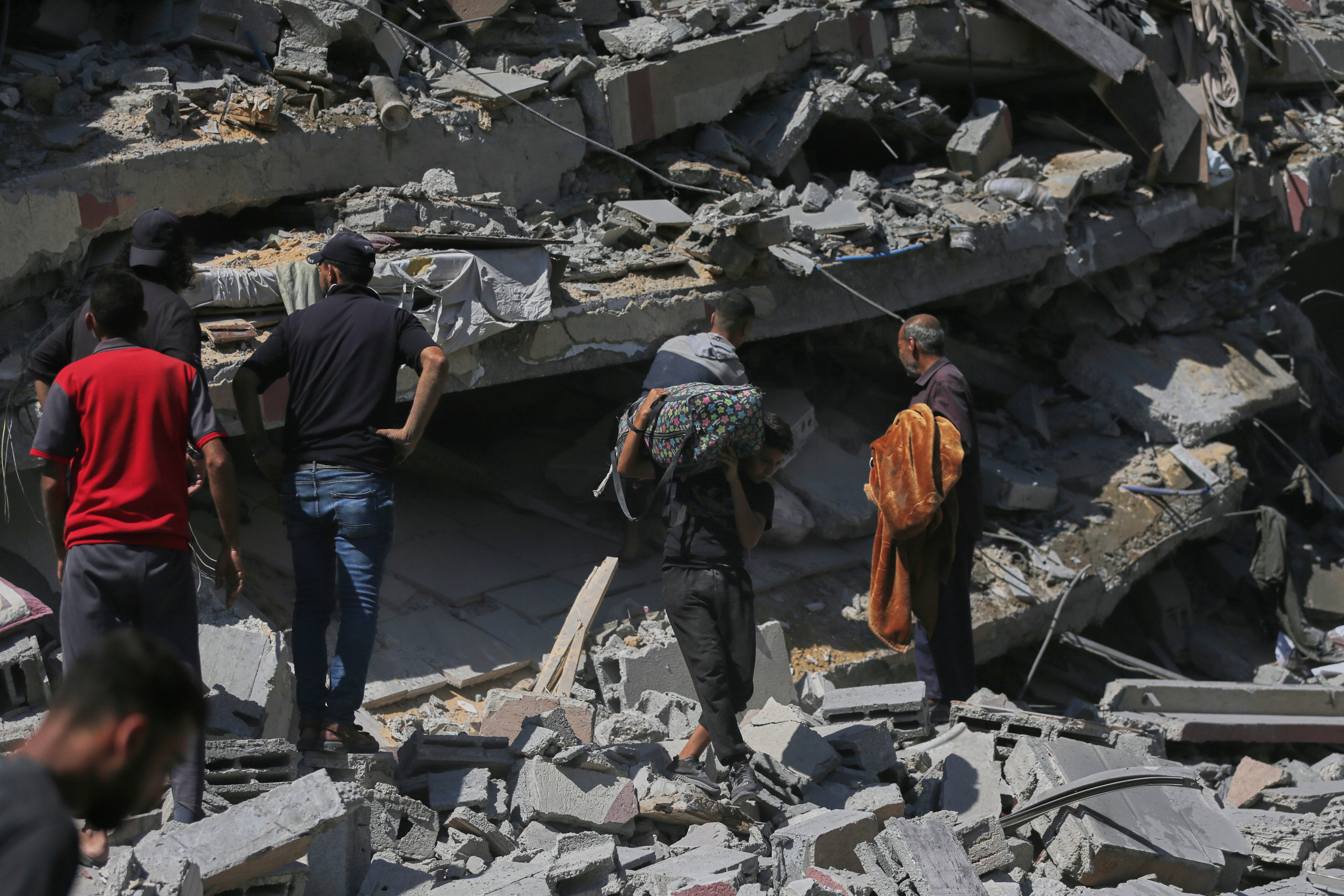 Palestinians inspect the rubble of a building after an Israeli military strike in Gaza City, Friday, Sept. 12, 2025. (AP Photo/Yousef Al Zanoun)