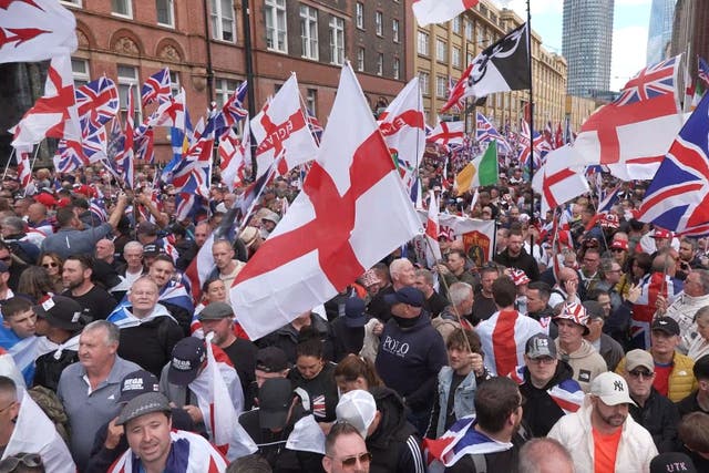 People flying Union and St George’s Cross flags during the Tommy Robinson-led Unite the Kingdom march and rally in London (Jamie Lashmar/PA)