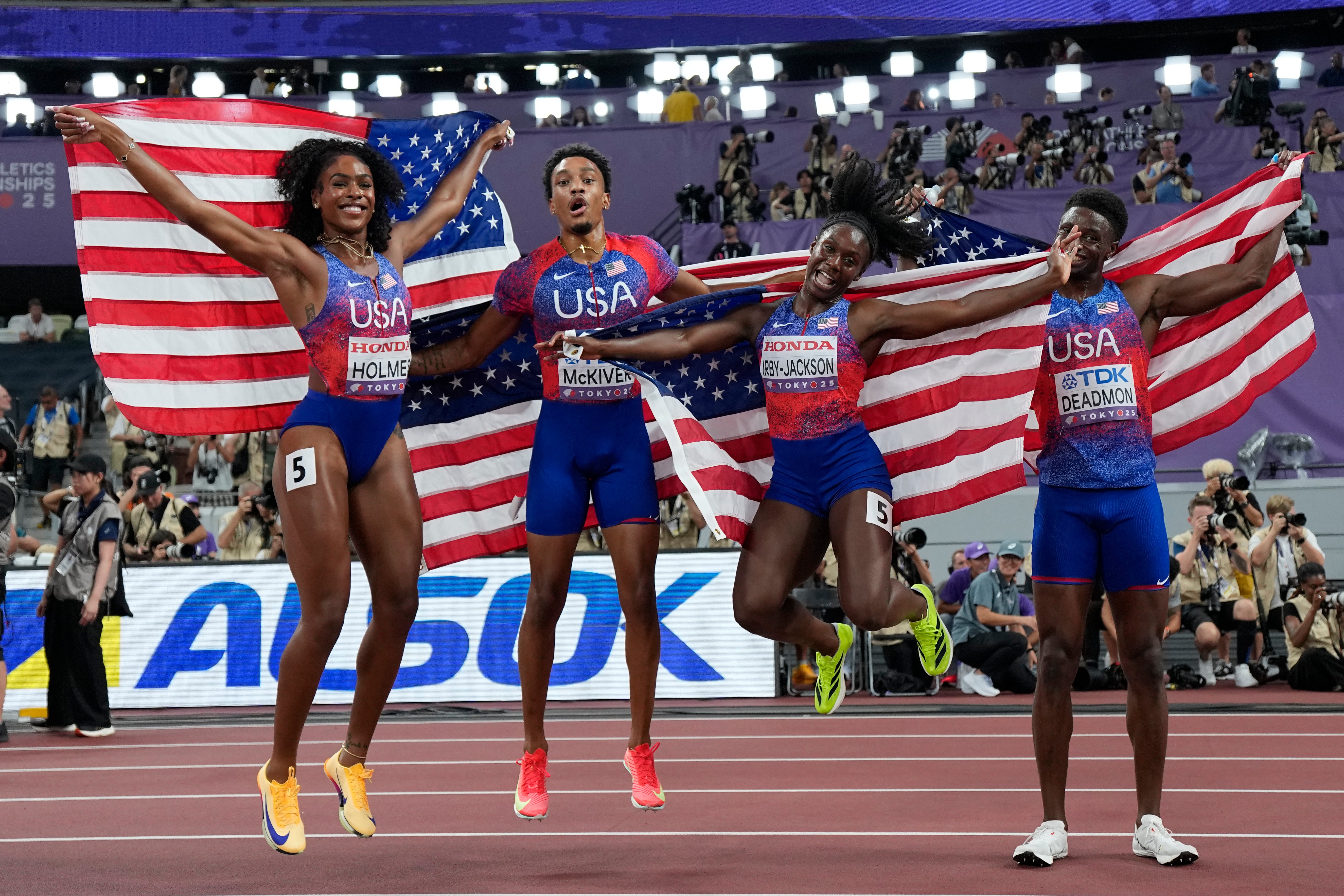 Alexis Holmes de los Estados Unidos, Jenoah McKiver, Lynn Irby-Jackson y Bryce Deadmon Pose después de ganar la medalla de oro en la final de relevos mixtos de 4 x 400 metros
