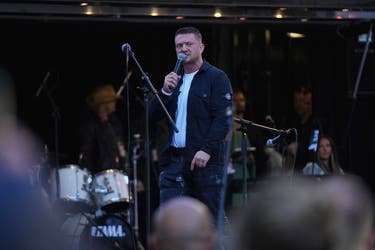 <p>Tommy Robinson speaks during the Unite the Kingdom march, which was attended by around 110,000 people</p>