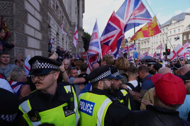 <p>Police officers form a line in front of demonstrators from the Tommy Robinson-led Unite the Kingdom march and rally </p>