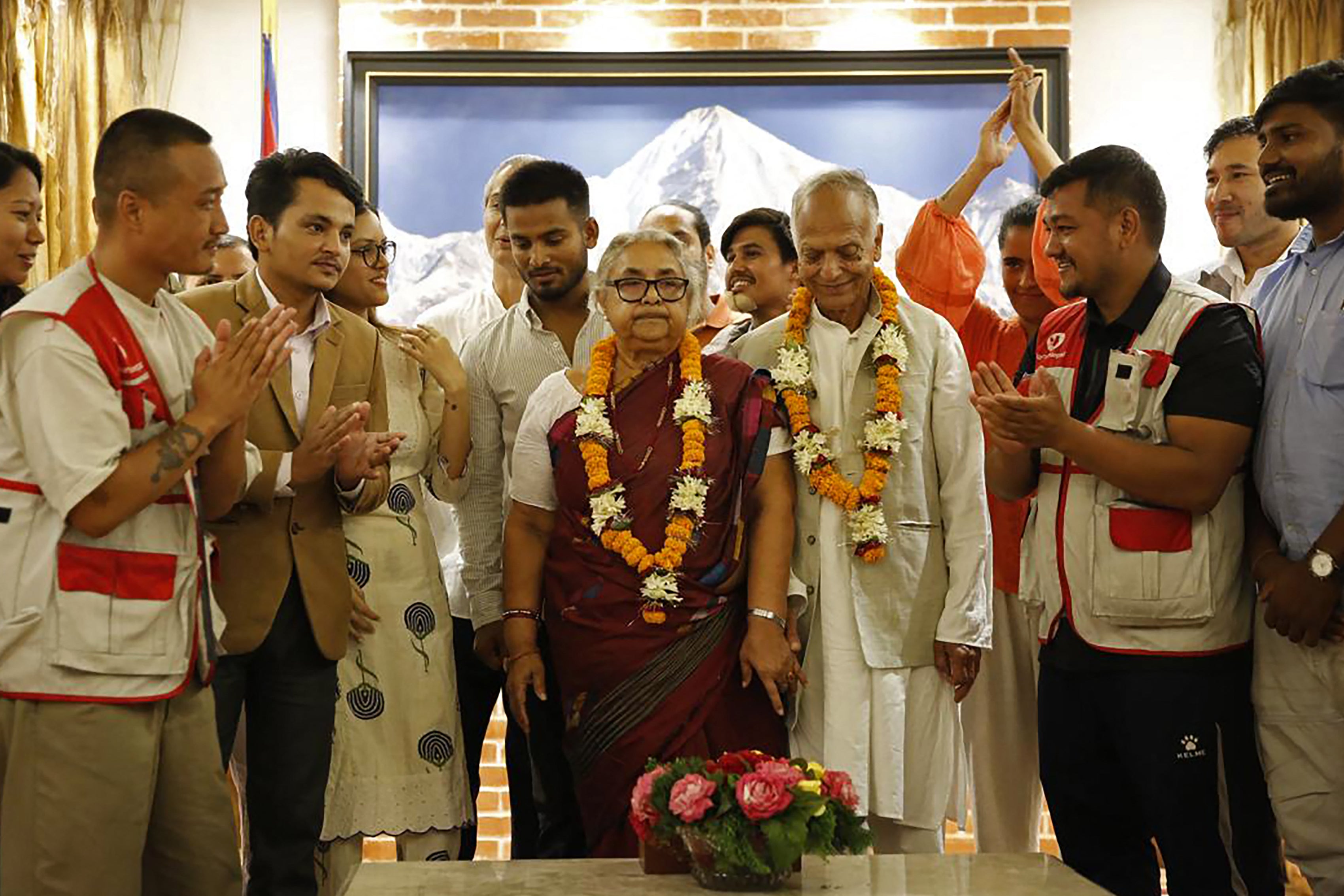 Nepal's newly appointed Prime Minister Sushila Karki (C) is congratulated by her supporters