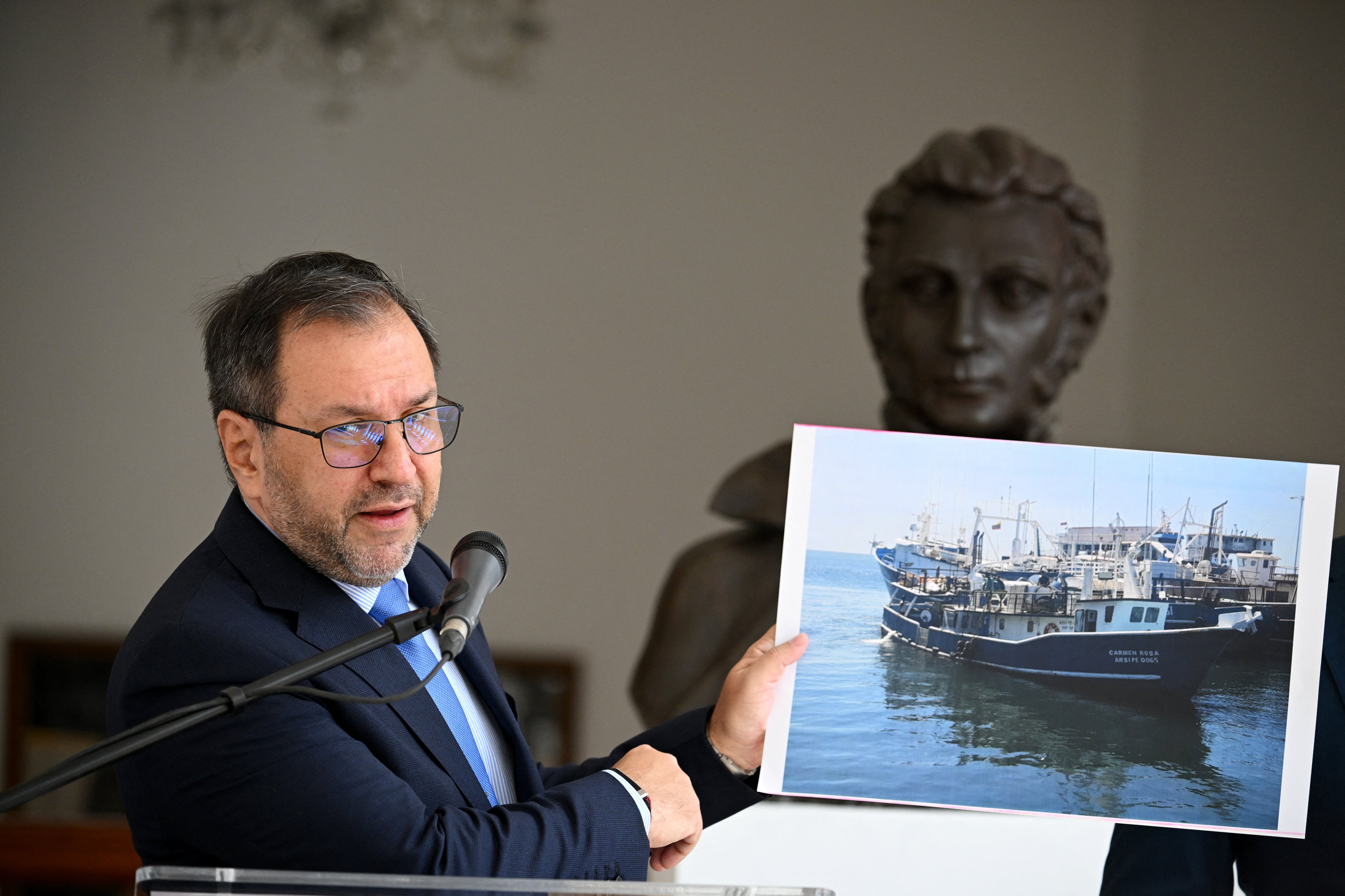 <p>Venezuela's Foreign Minister Yvan Gil shows a picture of a fishing boat during a press conference at the Ministry of Foreign Affairs in Caracas September 13. Venezuela on Saturday hit out at the United States for allegedly seizing a fishing boat for eight hours in its exclusive economic zone, as the US military patrols the Caribbean to target drug cartels</p>