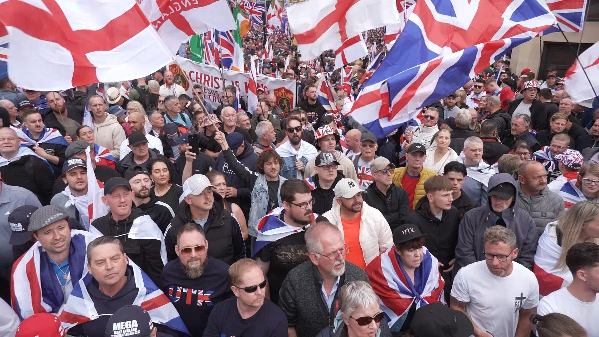 People fly Union Flags and the St George Cross during the Tommy Robinson-led ‘Unite the Kingdom’ march