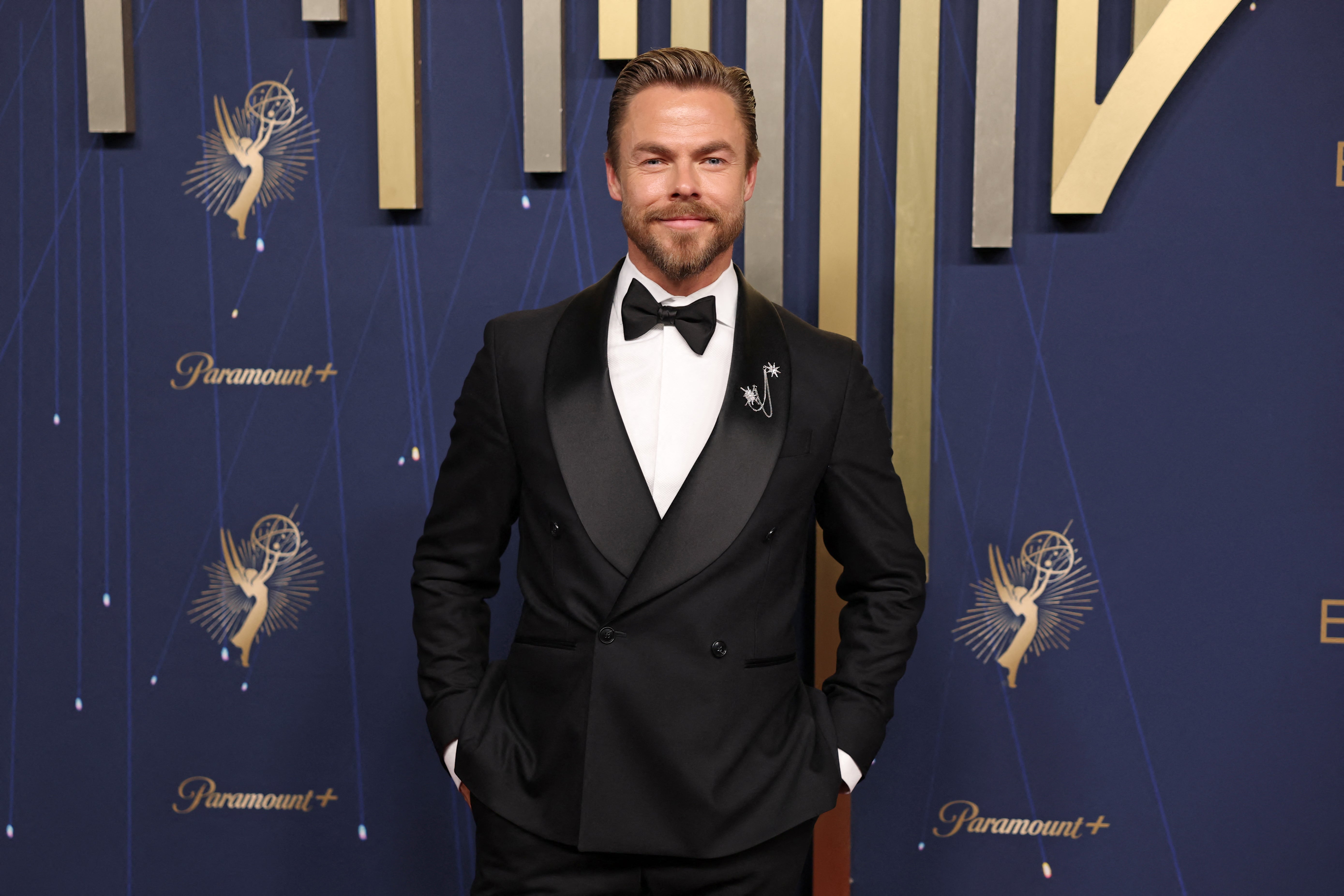 ‘Dancing With the Stars’ judge Derek Hough arrived at the Emmys in a classic fit: A black tuxedo and matching bowtie. But it was his silver brooch, with two stars on it, adorning his jacket that stood out the most