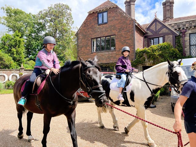 <p>Chinese summer camp students go horseback riding at Buckswood School in East Sussex under the guidance of a professional equestrian coach</p>