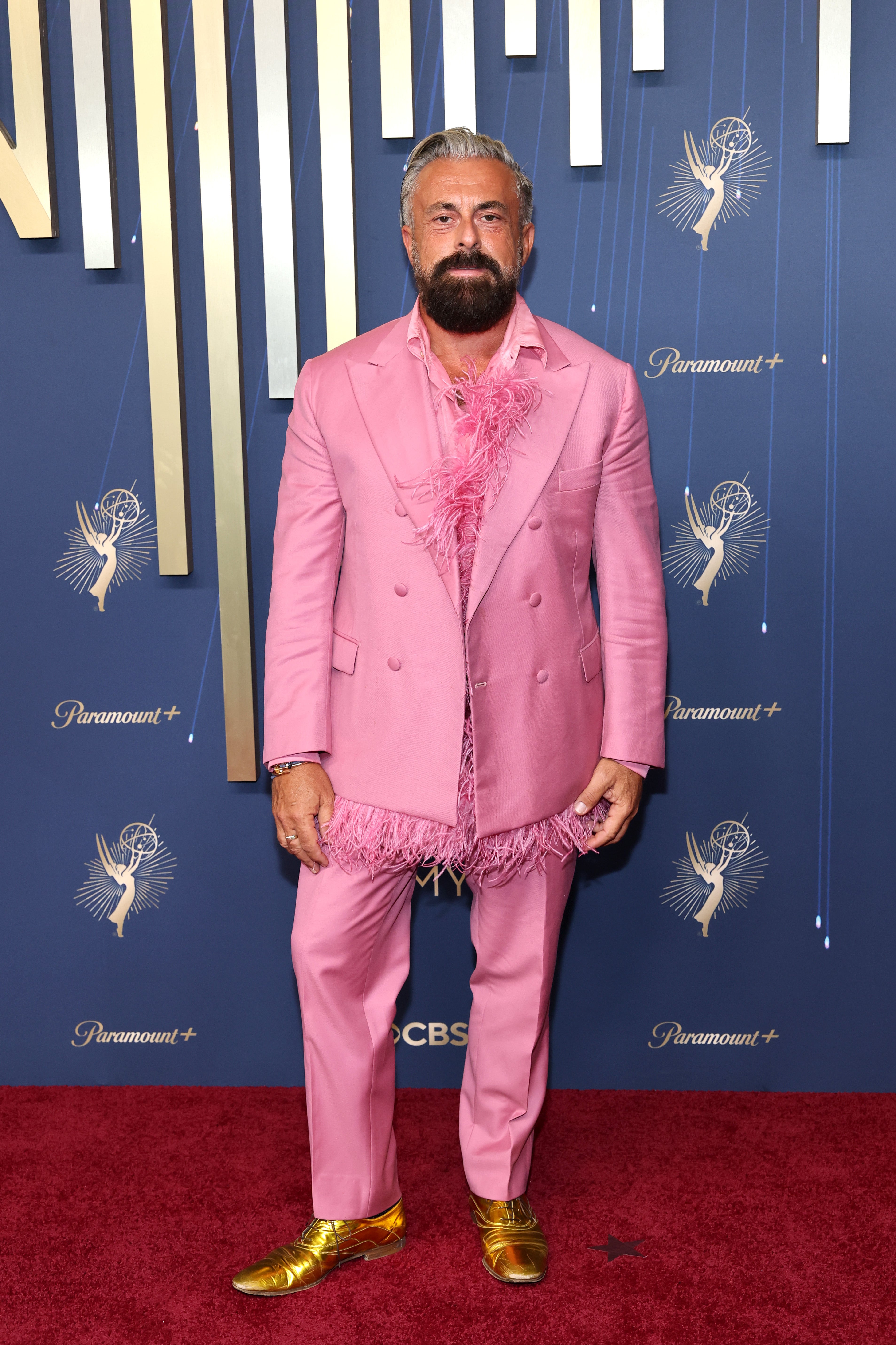 Daminano, an Italian journalist, left red carpet viewers unable to figure out where to look as his neon pink double-breasted suit was adorned with feathers, with gold shoes that made the overall outfit look too busy