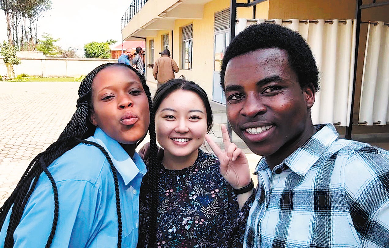 <p>Zhang Wei (centre) poses with local youth volunteers during a field mission in Muhanga, Rwanda, on 19 November</p>