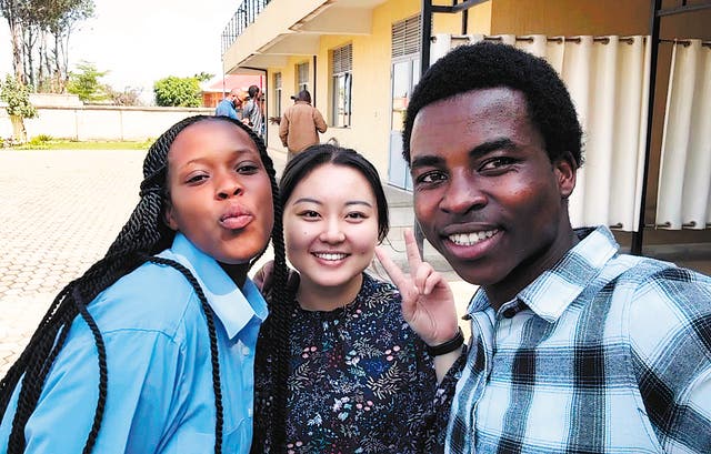 <p>Zhang Wei (centre) poses with local youth volunteers during a field mission in Muhanga, Rwanda, on 19 November</p>