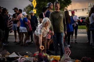 A mourner pays respects to Kirk at the memorial