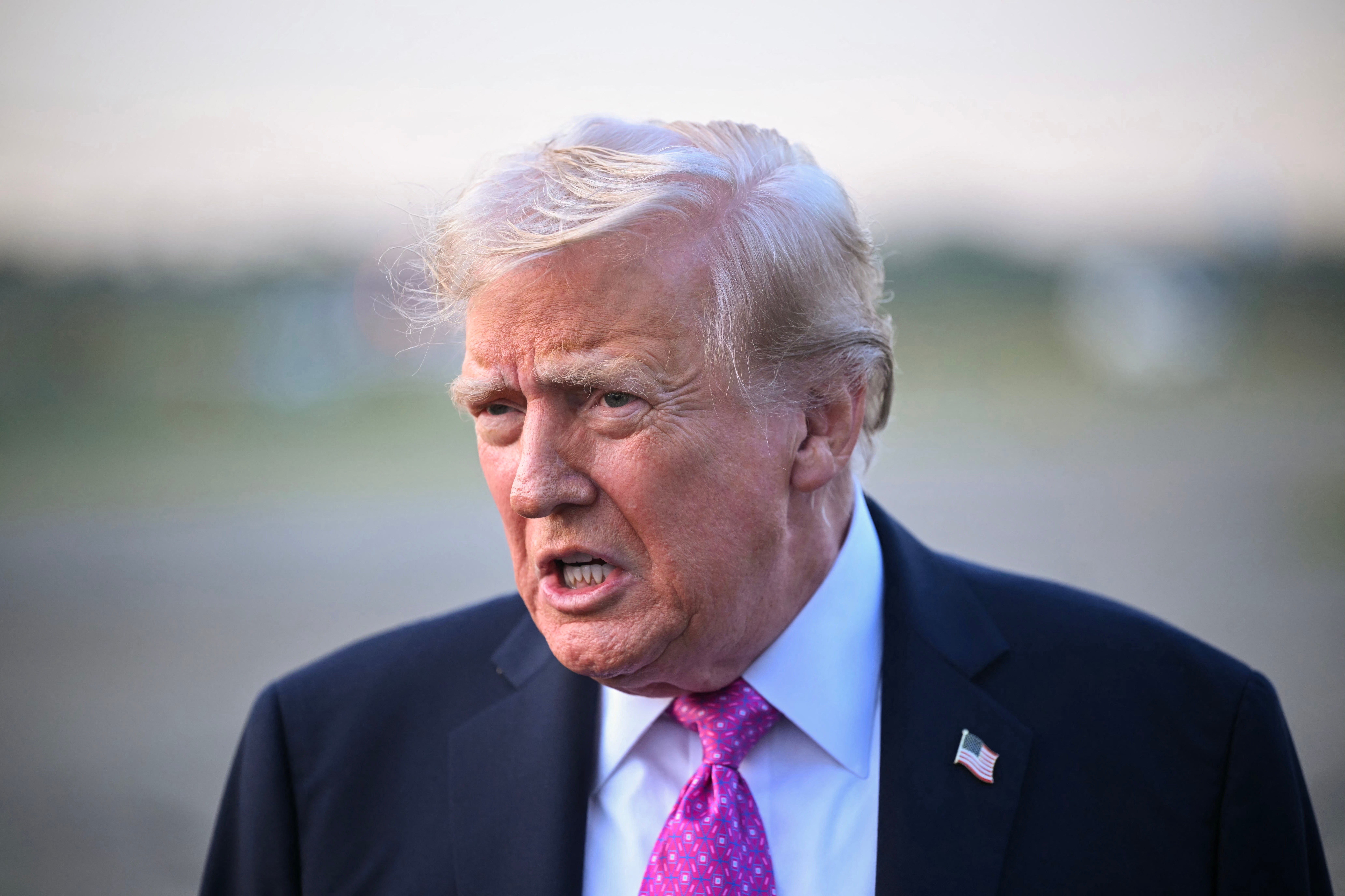 <p>US president Donald Trump speaks to members of the press before boarding Air Force One at Morristown Municipal Airport in Morristown in New Jersey</p>