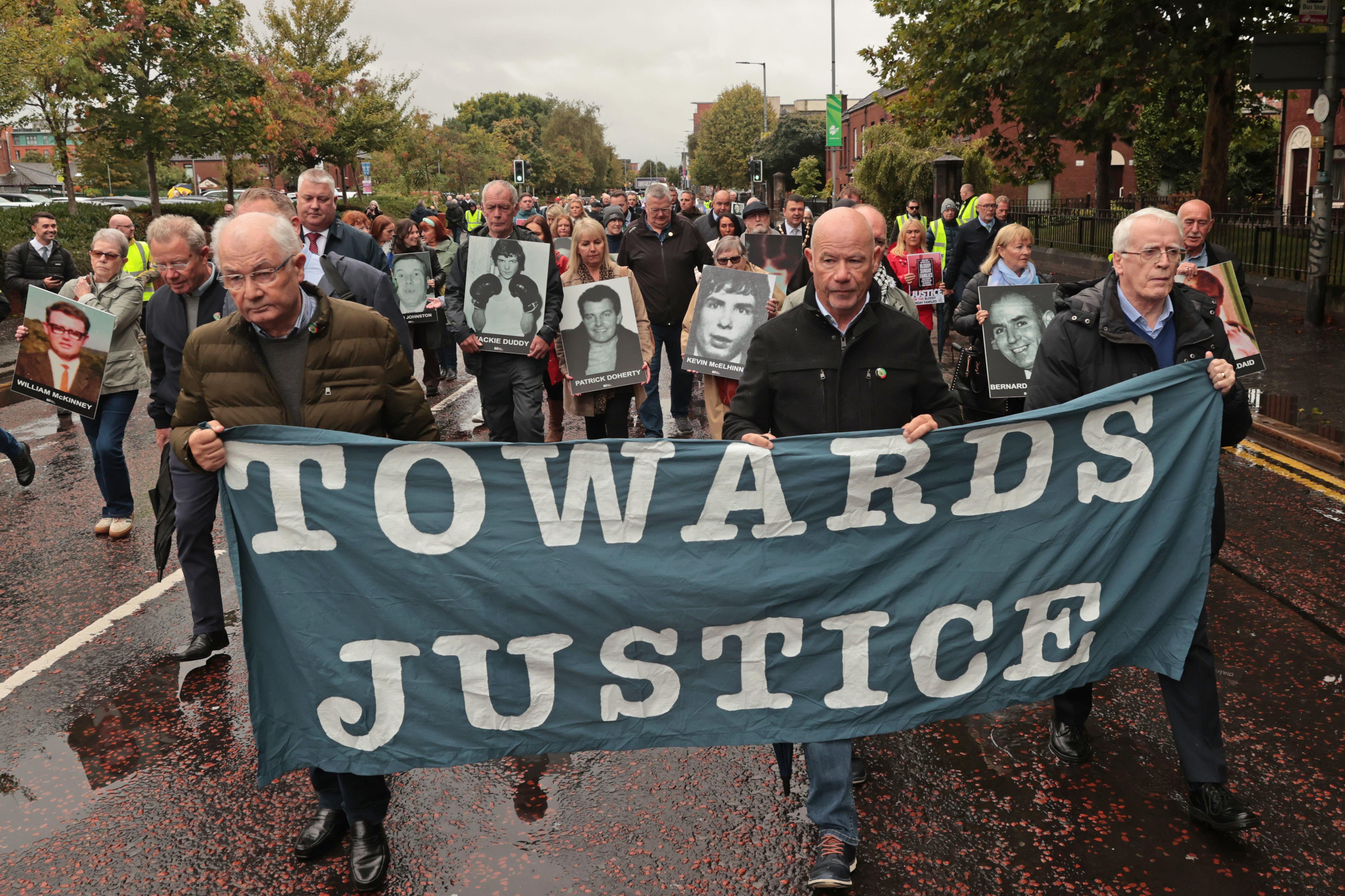 A march in support of families walking towards Belfast Crown Court (Liam McBurney/PA)