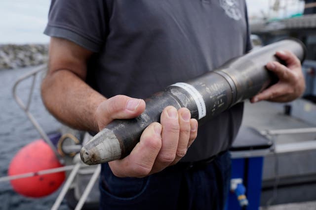 <p>A representative of an ammunition recovery service shows a 78 millimetre artillery grenade as an example during a press tour to show the recovering of ammunition from World War II in the Baltic Sea, in Boltenhagen, Germany</p>