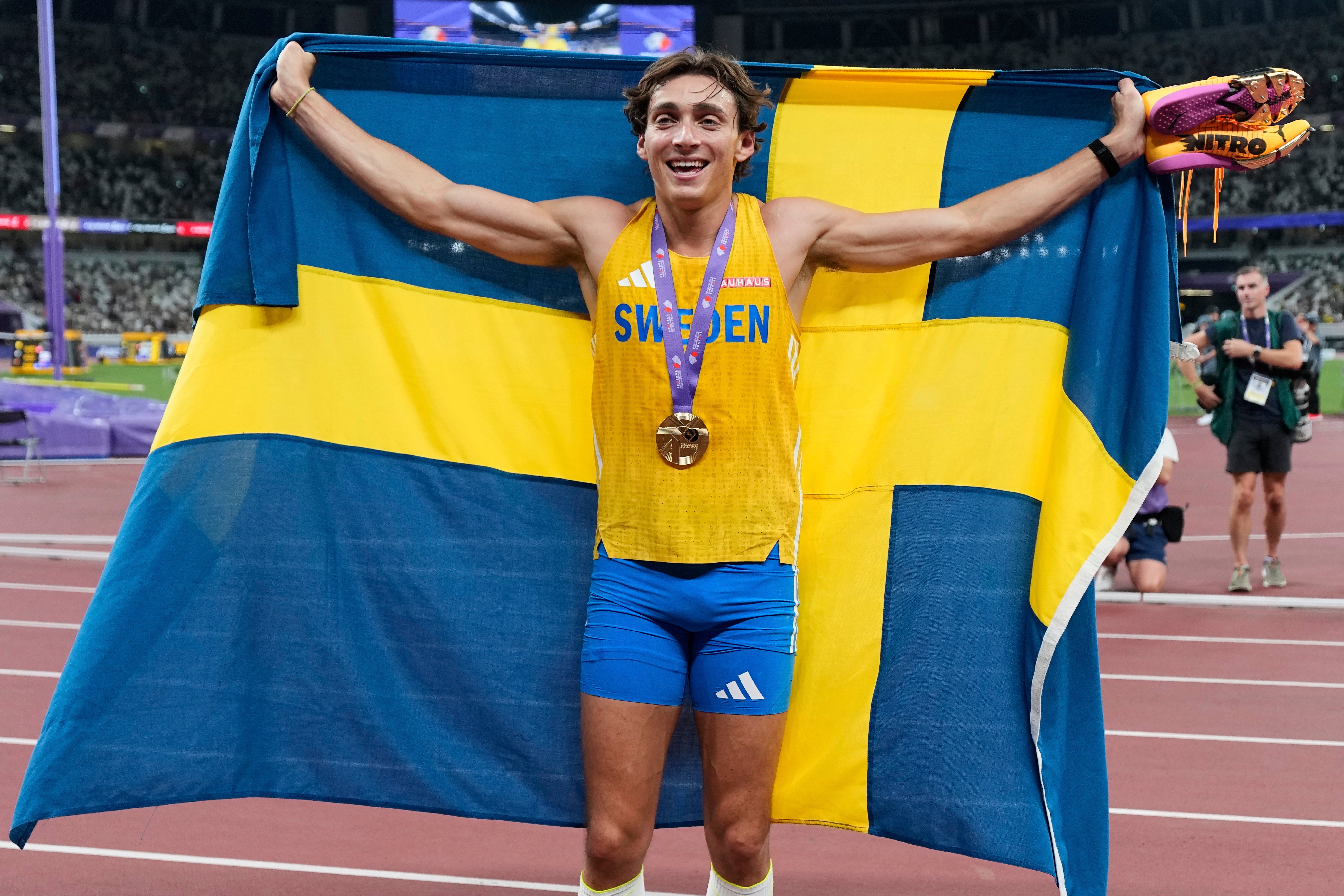 Sweden's Armand Duplantis reacts after winning gold and setting a world record in the men's pole vault final