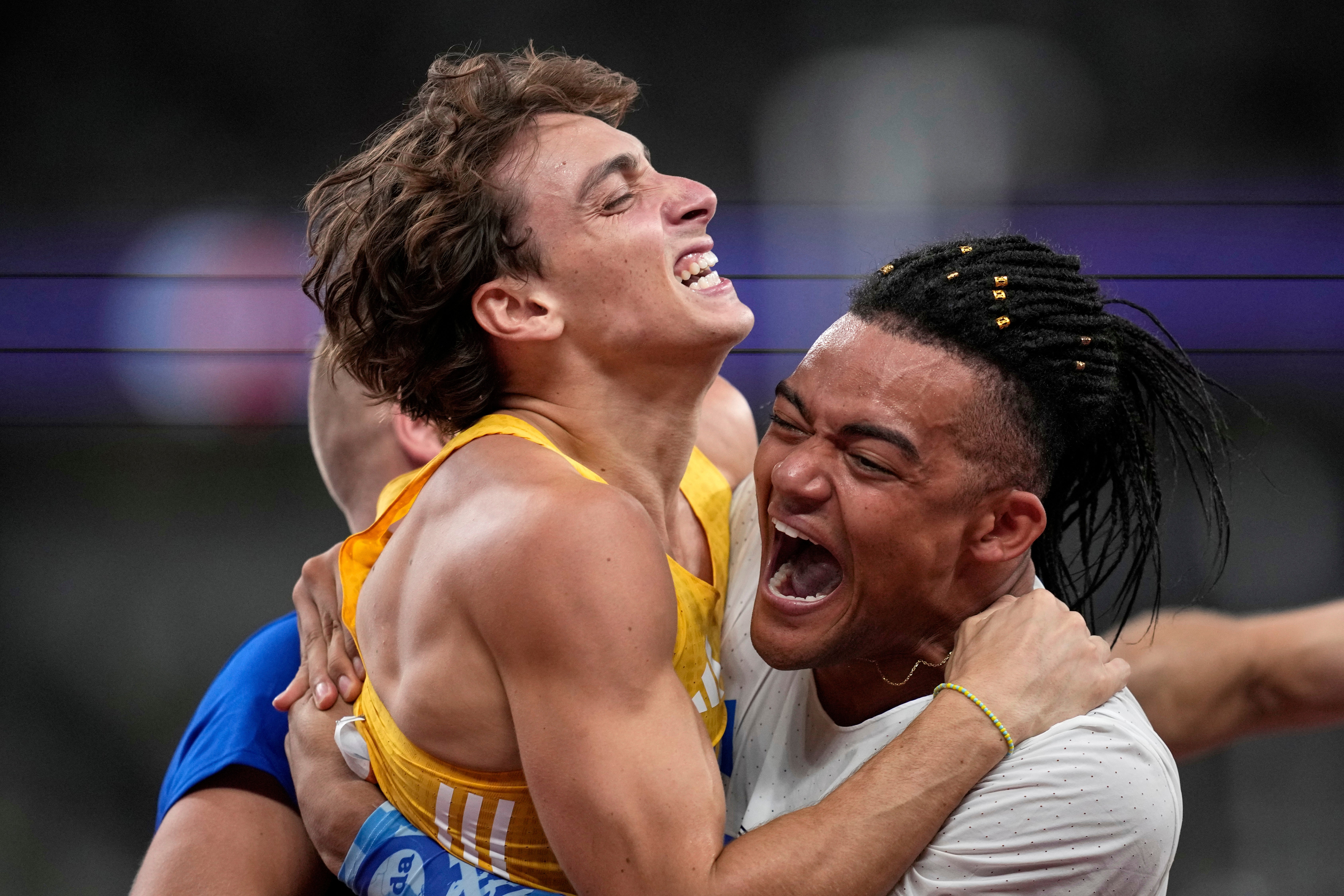 Sweden's Armand Duplantis celebrates with United States' Sam Kendricks and Greece's Emmanouil Karalis