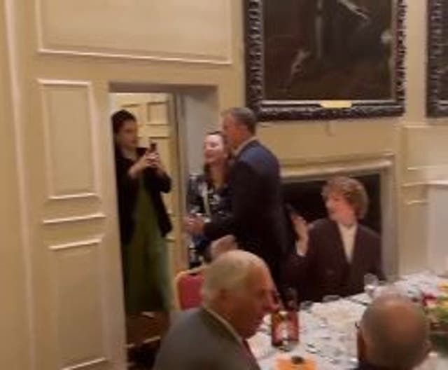 <p>A man appears to usher a female protester out, filmed by an onlooker</p>