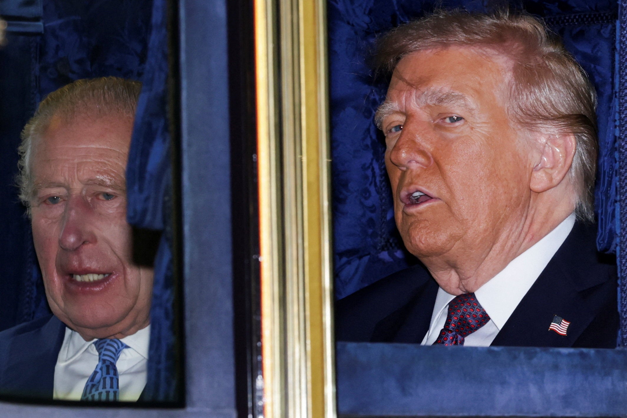 King Charles and US President Donald Trump sit in a carriage during the procession through the Windsor estate
