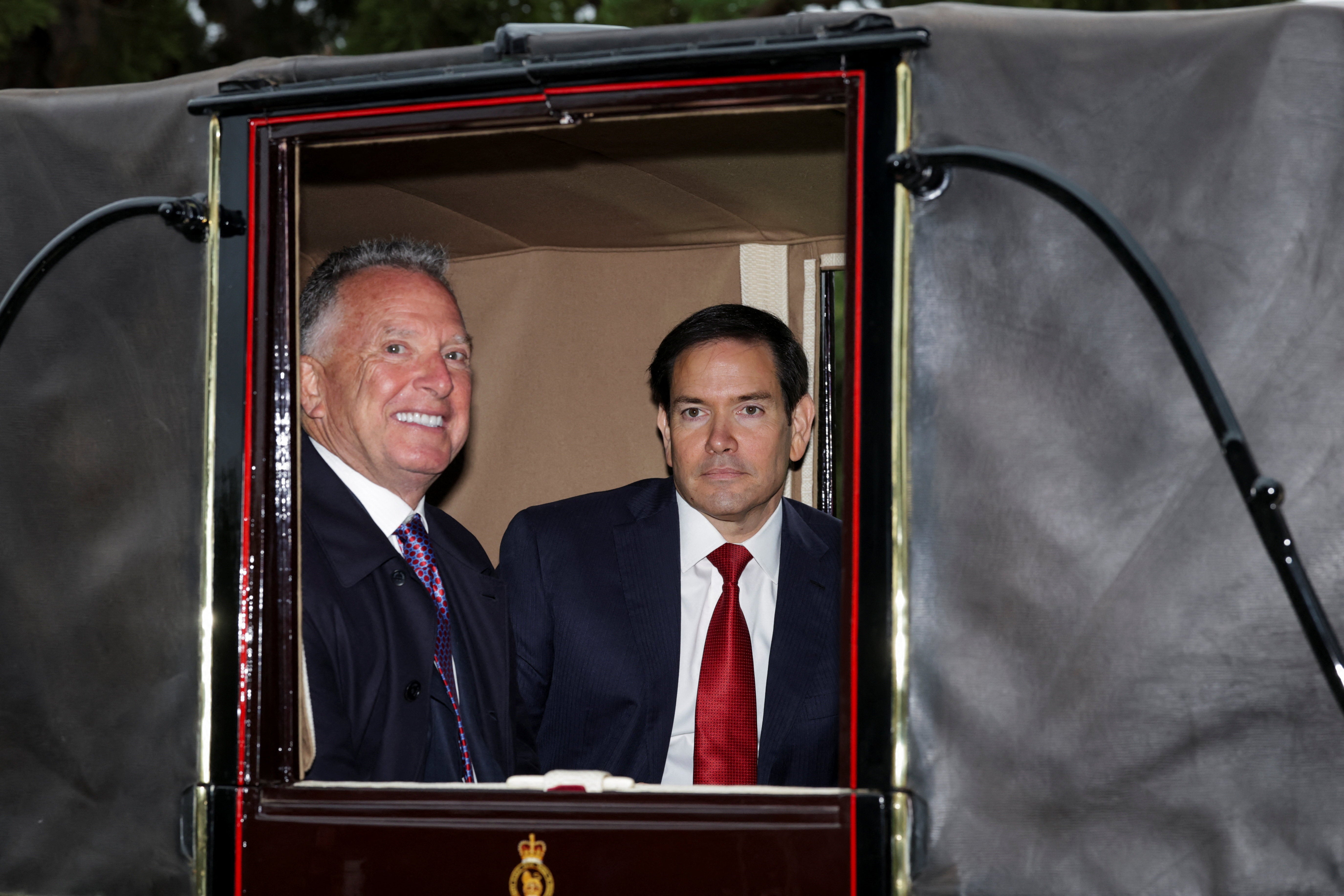 US Secretary of State Marco Rubio and White House Special Envoy Steve Witkoff ride in a carriage during the procession