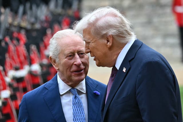 <p>Britain's King Charles III (L) and US President Donald Trump (R) talk as they inspect a guard of honour during a ceremonial welcome in the Quadrangle at Windsor Castle, in Windsor, </p>