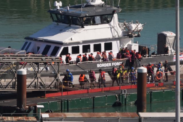 <p>A group of people thought to be migrants are brought into the Border Force compound in Dover, Kent, following a small boat incident in the Channel in early September</p>