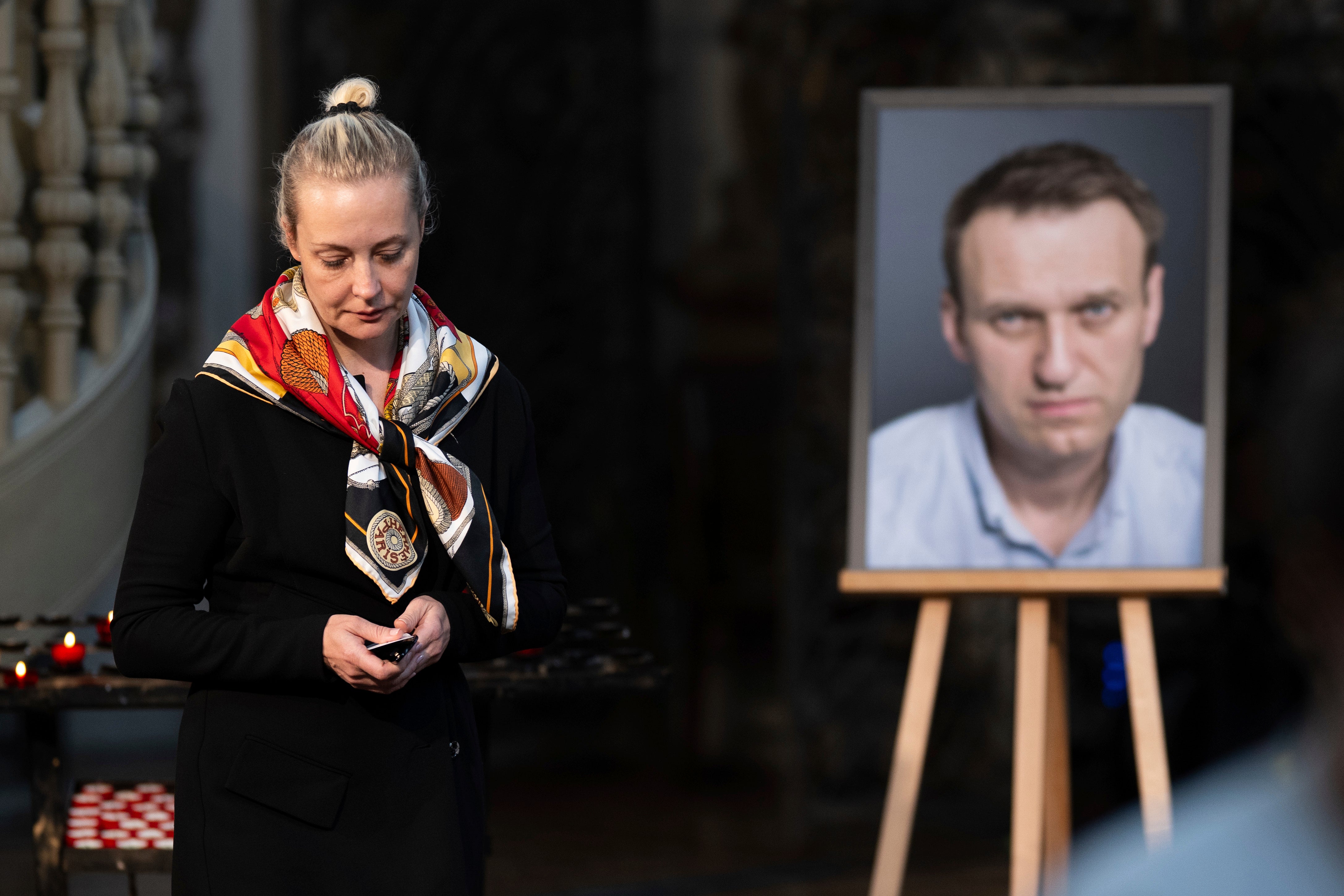 Yulia Navalnaya, widow of Russian opposition leader Alexei Navalny walks away from his picture in 2024