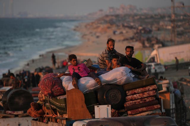 <p>Displaced Palestinians flee Gaza City carrying their belongings along the coastal road towards southern Gaza (Abdel Kareem Hana/AP photo)</p>