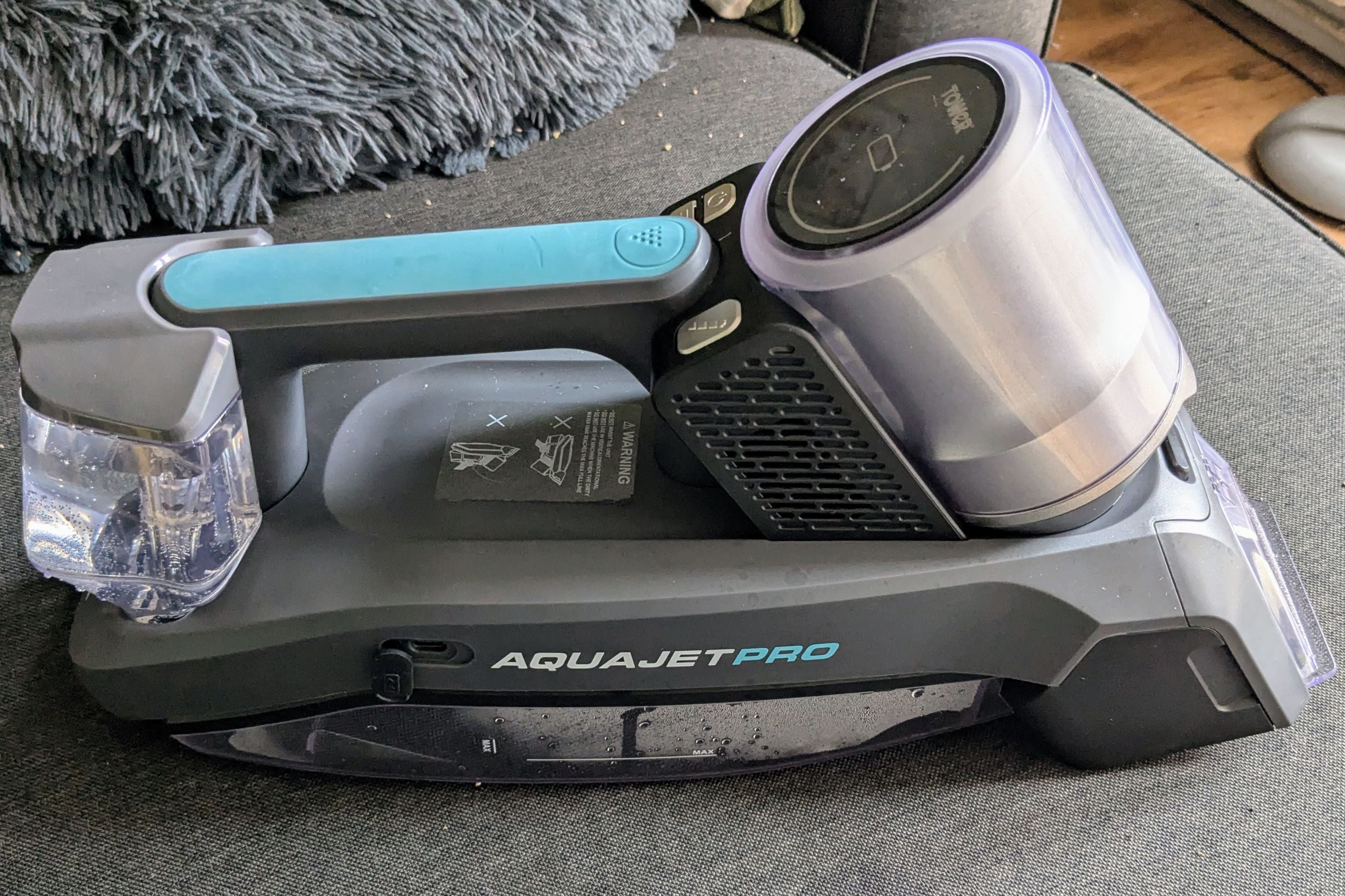 Tower aquajet pro handy cordless spot cleaner on a sofa