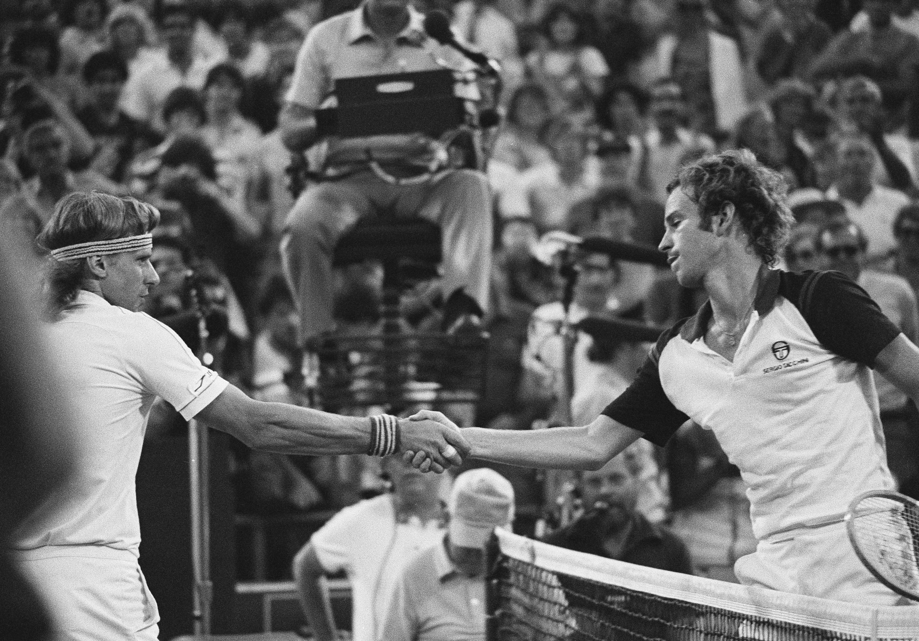 John McEnroe, right, shakes hands after defeating Björn Borg, left, in the final at the National Tennis Center in New York, Sept. 13, 1981