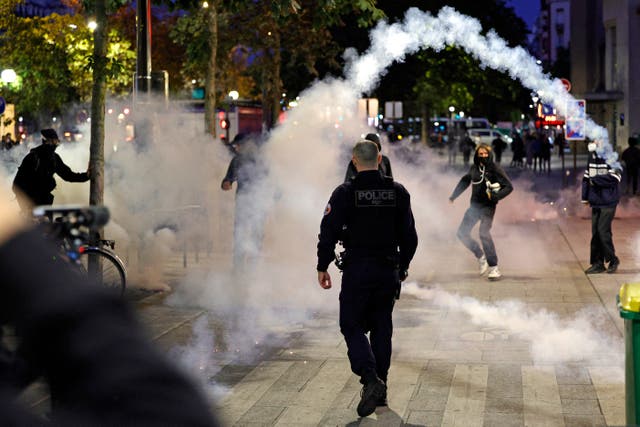 <p>A teargas canister is thrown as police and demonstrators clash in Paris, on 18 September</p>