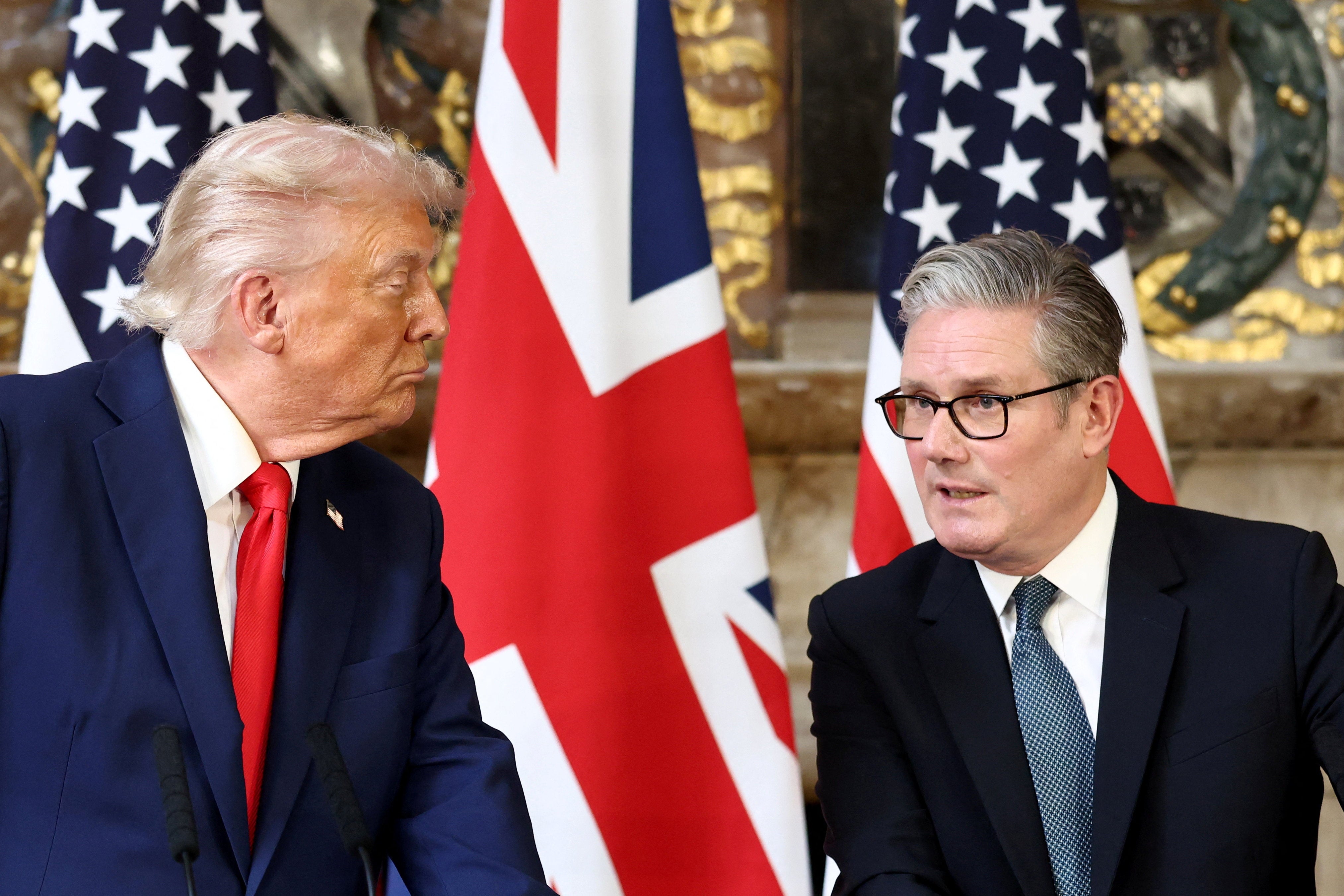 U.S. President Donald Trump listens as British Prime Minister Keir Starmer speaks during a press conference at Chequers
